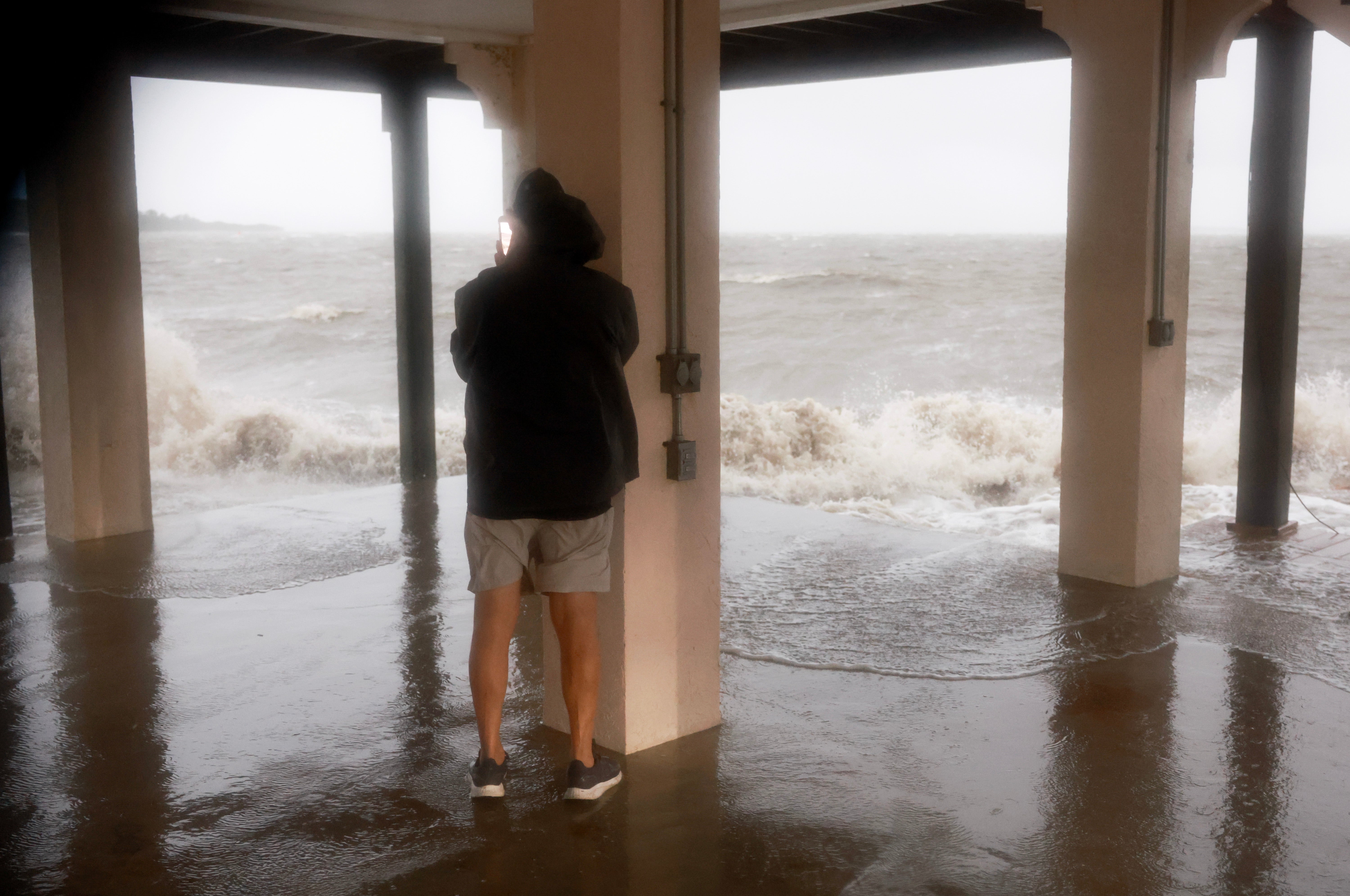 Joey Larsen checks on his neighborhood as high winds, rain and storm surge from Hurricane Debby inundate the area on August 05, 2024, in Cedar Key, Florida