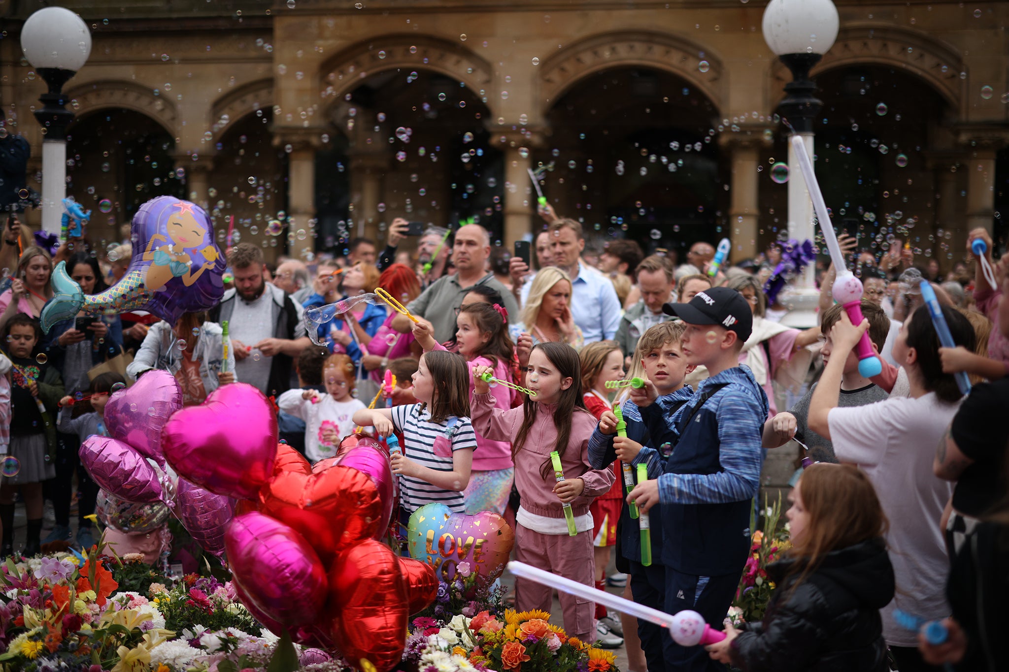 People gather to mourn victims of the Southport knife attack by holding a vigil in town, August 5