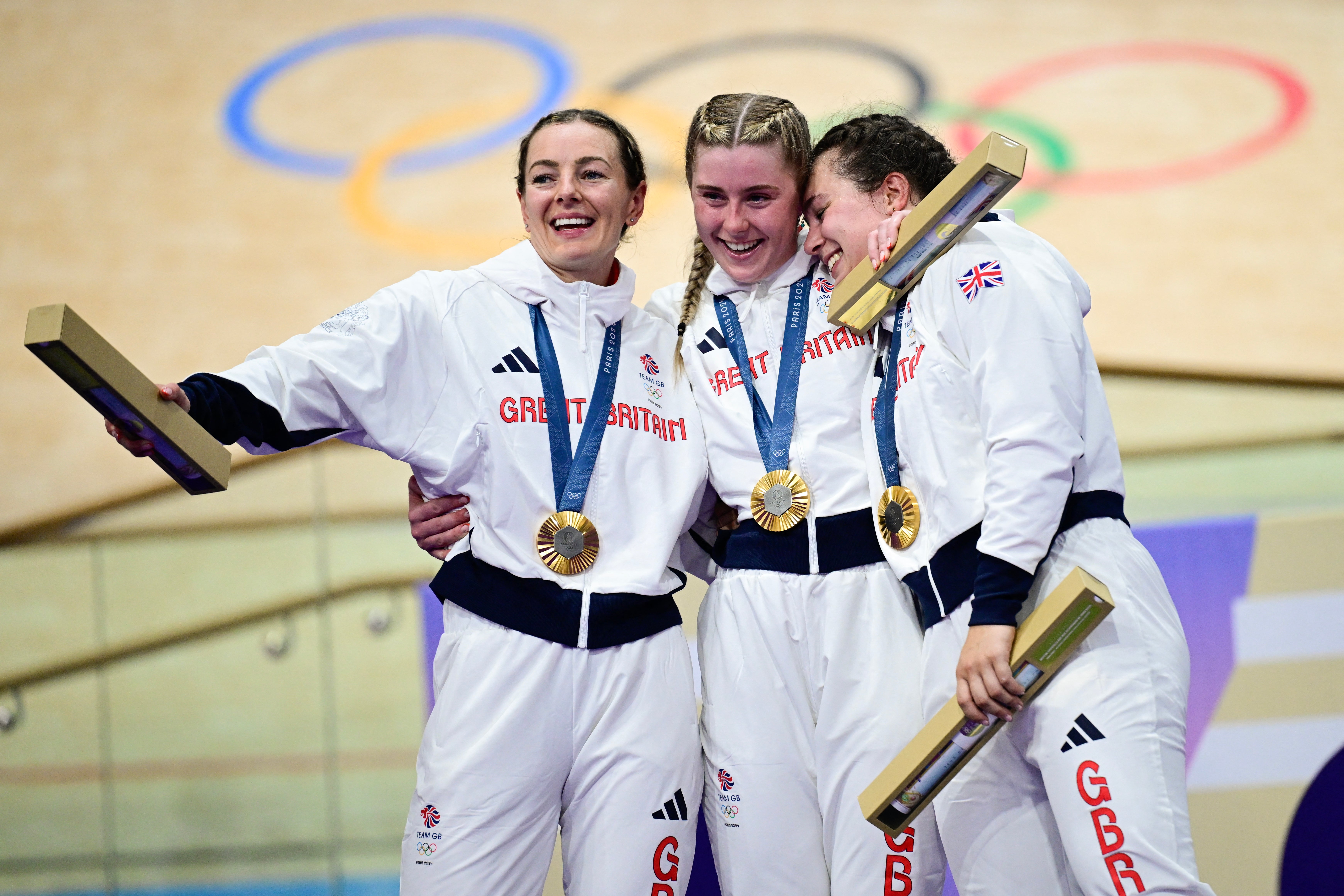 Britain's Katy Marchant, Britain's Sophie Capewell and Britain's Emma Finucane celebrate their gold medal