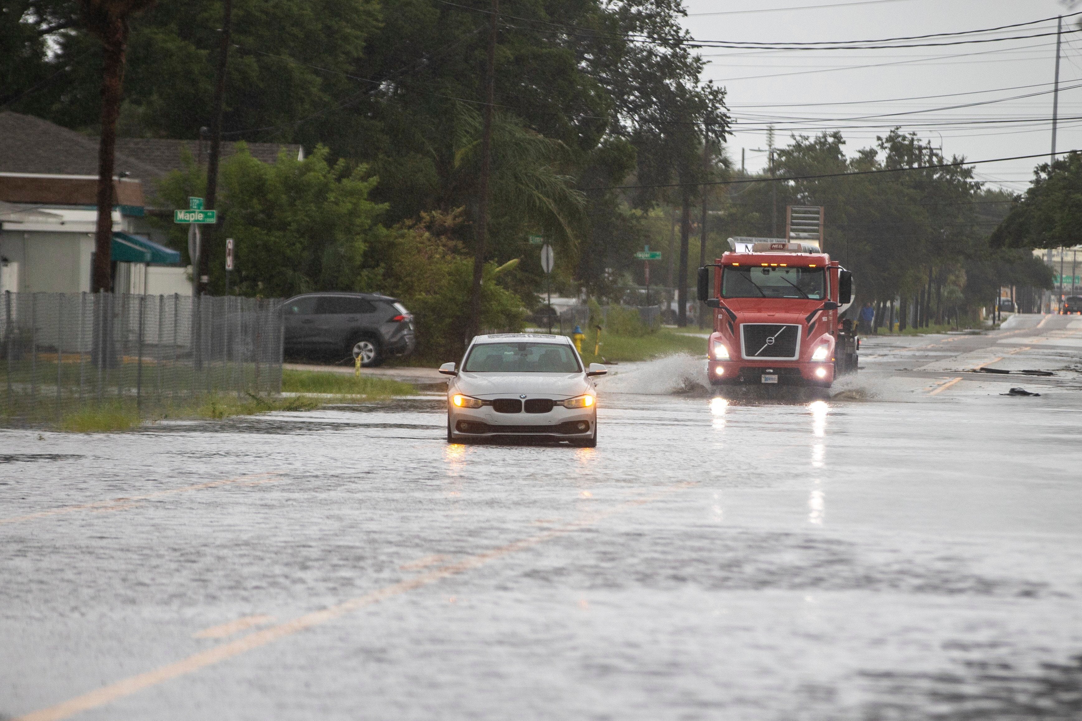 A vehicle is disabled in the flood water along 22nd street on Monday morning, in Tampa, Florida, as Hurricane Debby passes the Tampa Bay area offshore