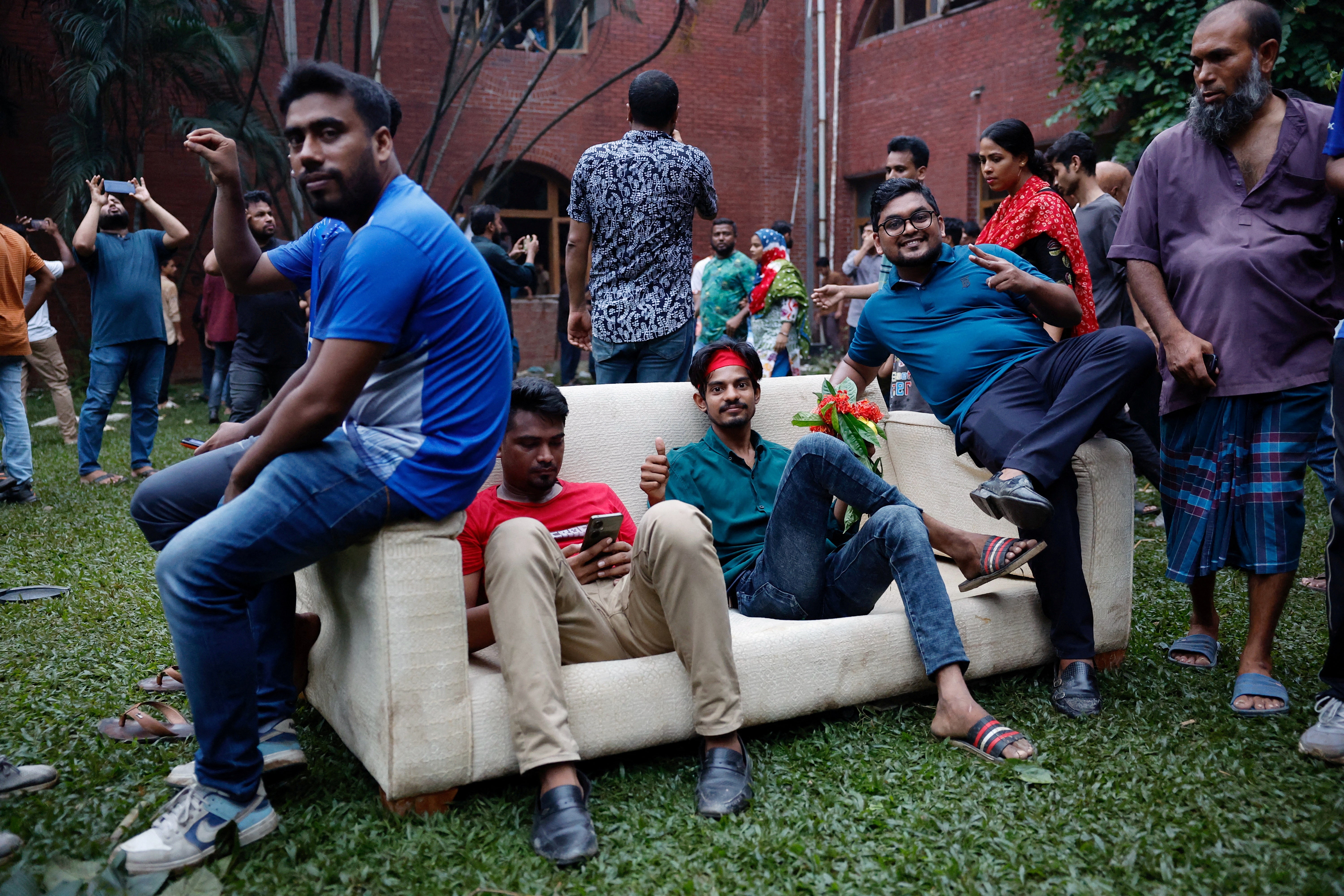 People enter the Ganabhaban sitting on a sofa brought outside