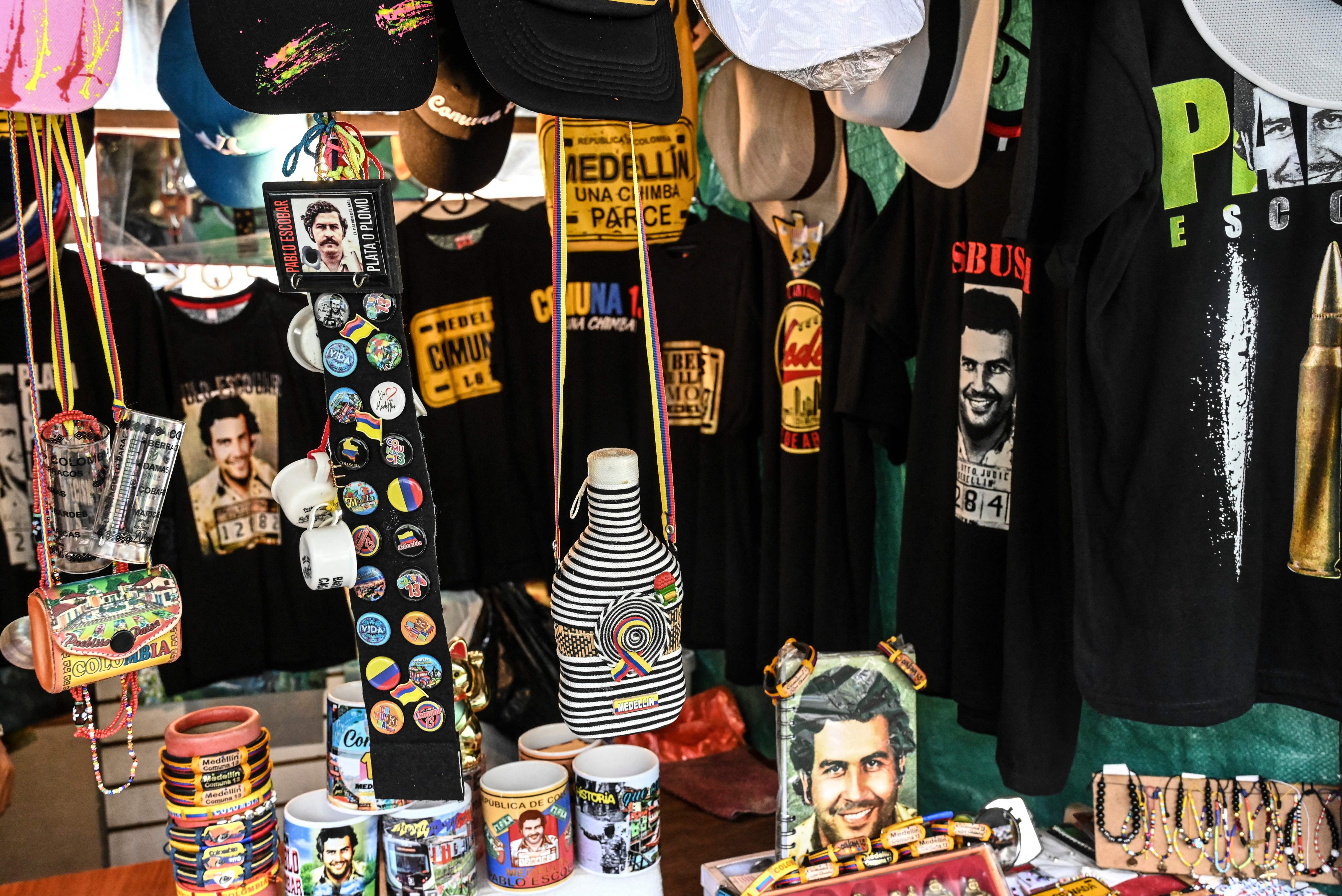 Souvenirs and clothes with the images of the late Colombian drug baron Pablo Escobar are seen on a shop at the Comuna 13 neighbourhood in Medellin, Colombia, on September 28, 2022