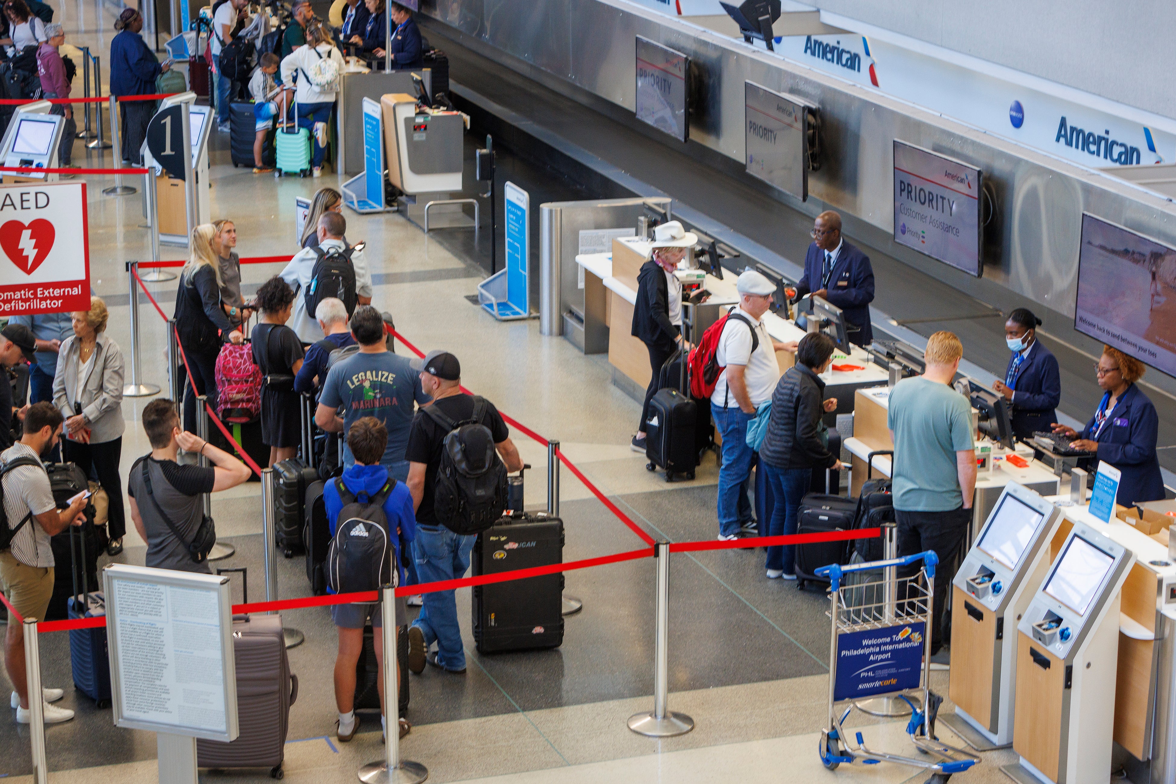 Passengers wait in line at American Airlines in Terminal B at the Philadelphia International Airport