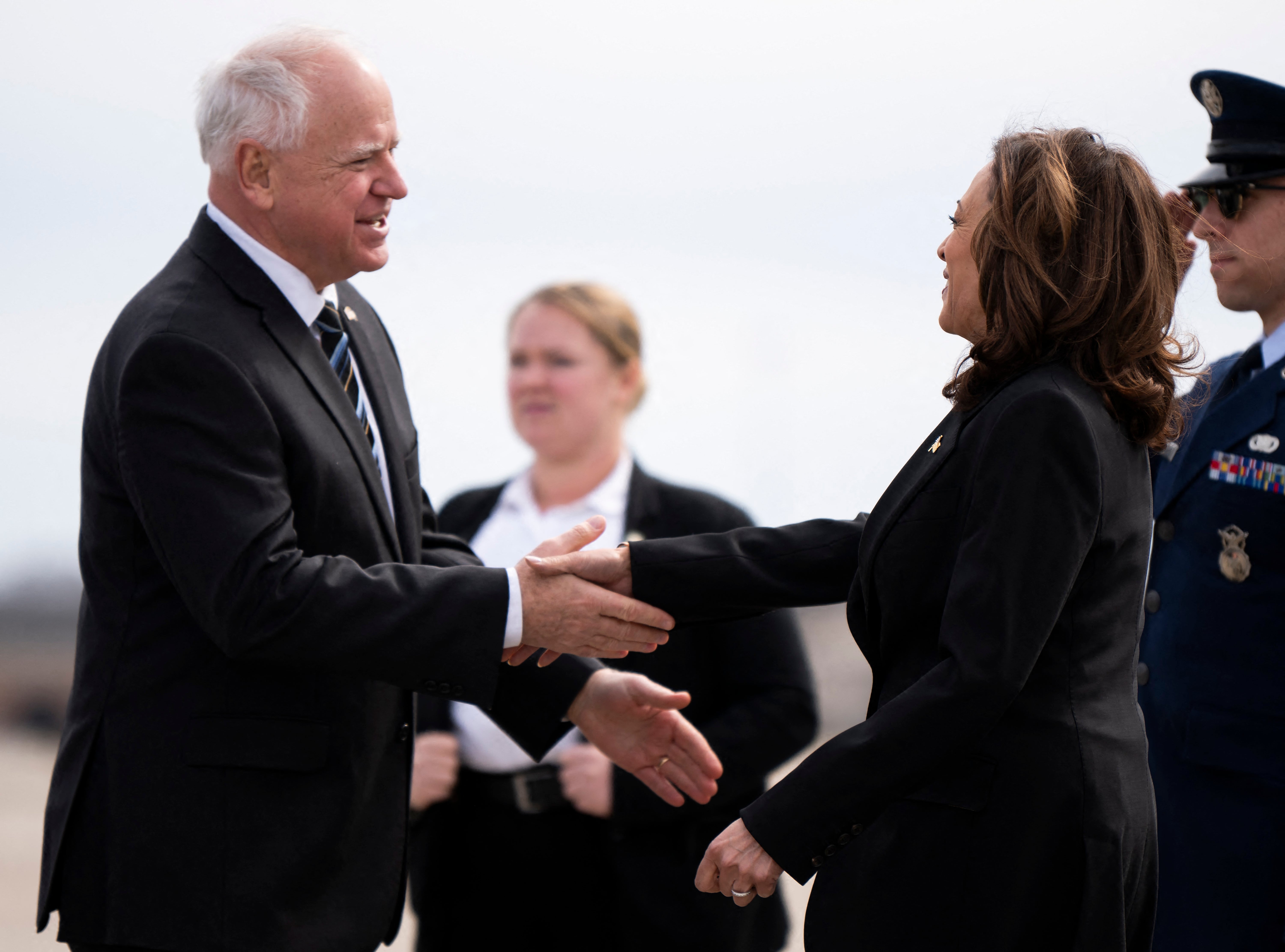 Tim Walz (left) greets Kamala Harris (right)