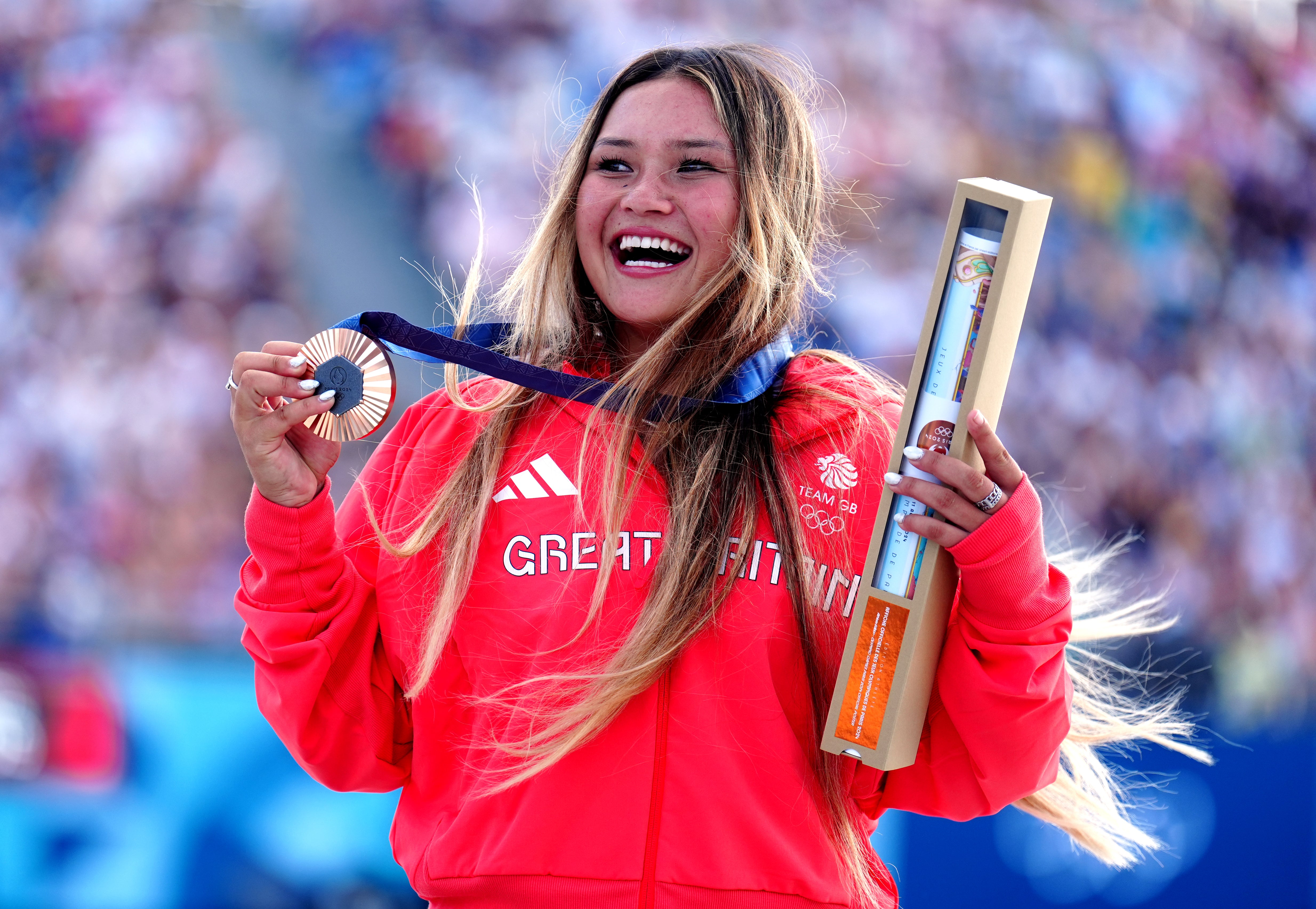 Sky Brown celebrates with her bronze medal in Paris