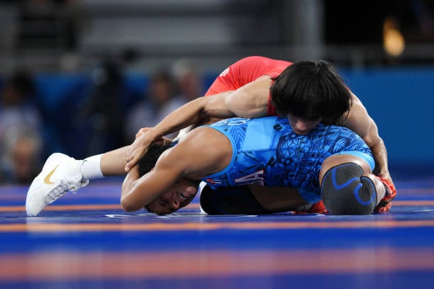 Vinesh Phogat of Team India (red) competes with Yusneylis Guzman Lopez of Team Cuba (blue) during the Wrestling Women’s Freestyle 50kg Semifinal on day eleven of the Olympic Games Paris 2024