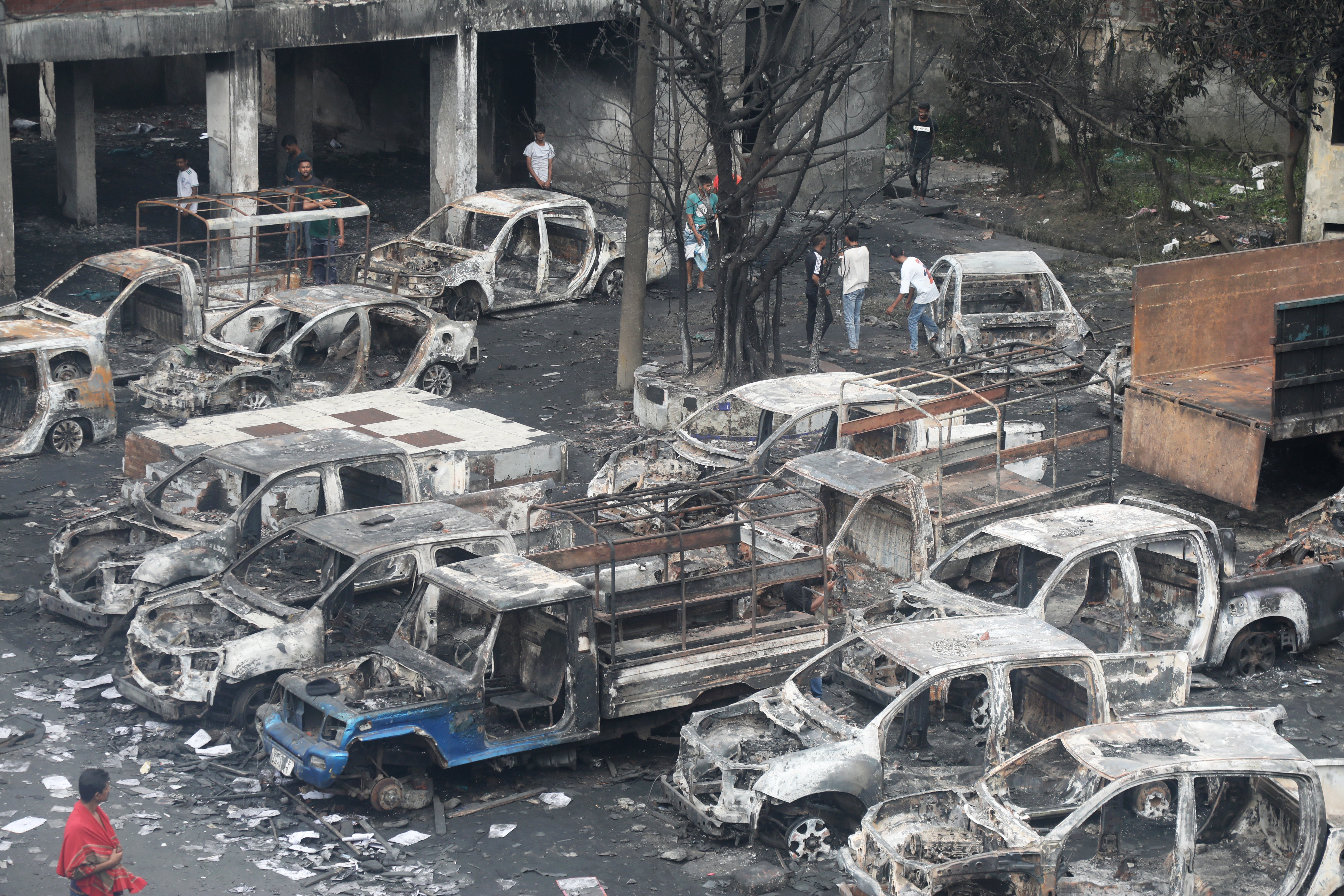 Charred vehicles at Jatrabari police station that was attacked by protesters in Dhaka