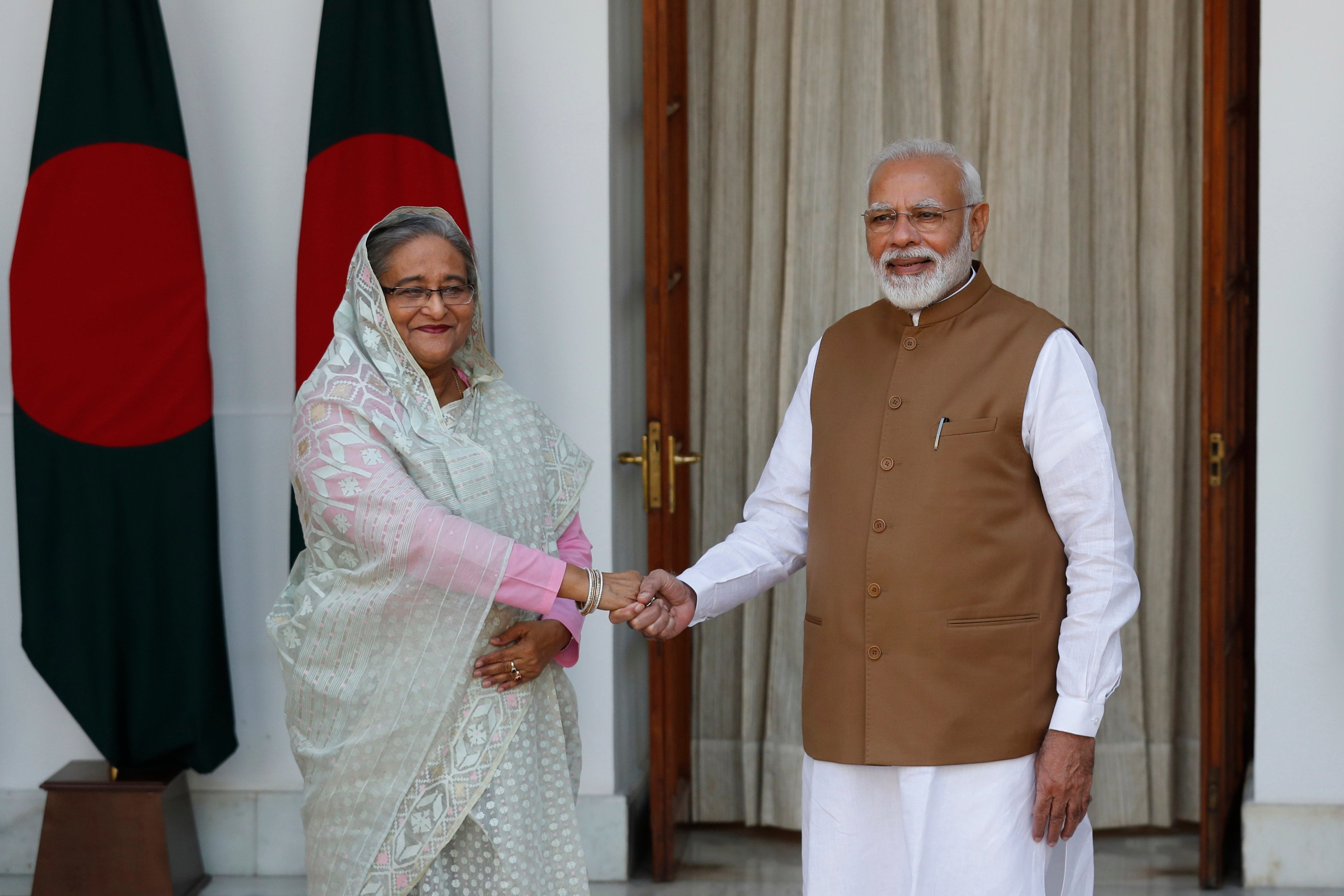 File: Indian prime minister Narendra Modi shakes hand with Sheikh Hasina