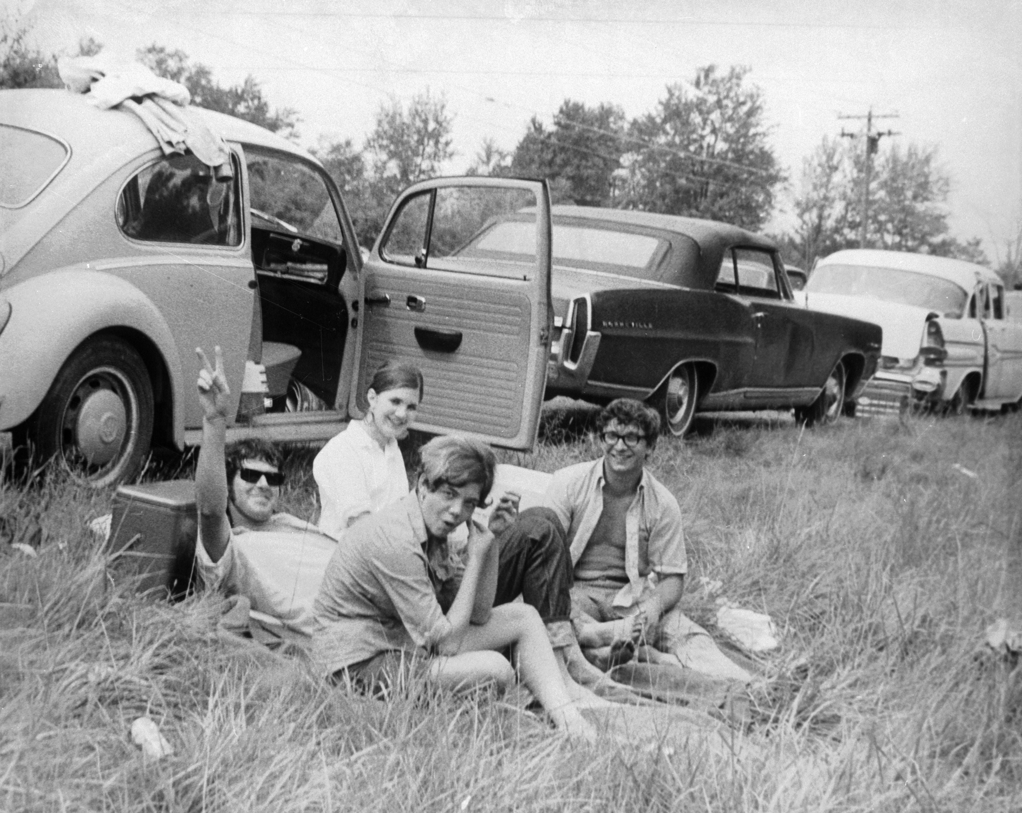 Communal living: friends enjoy a picnic by their car at Woodstock 1969