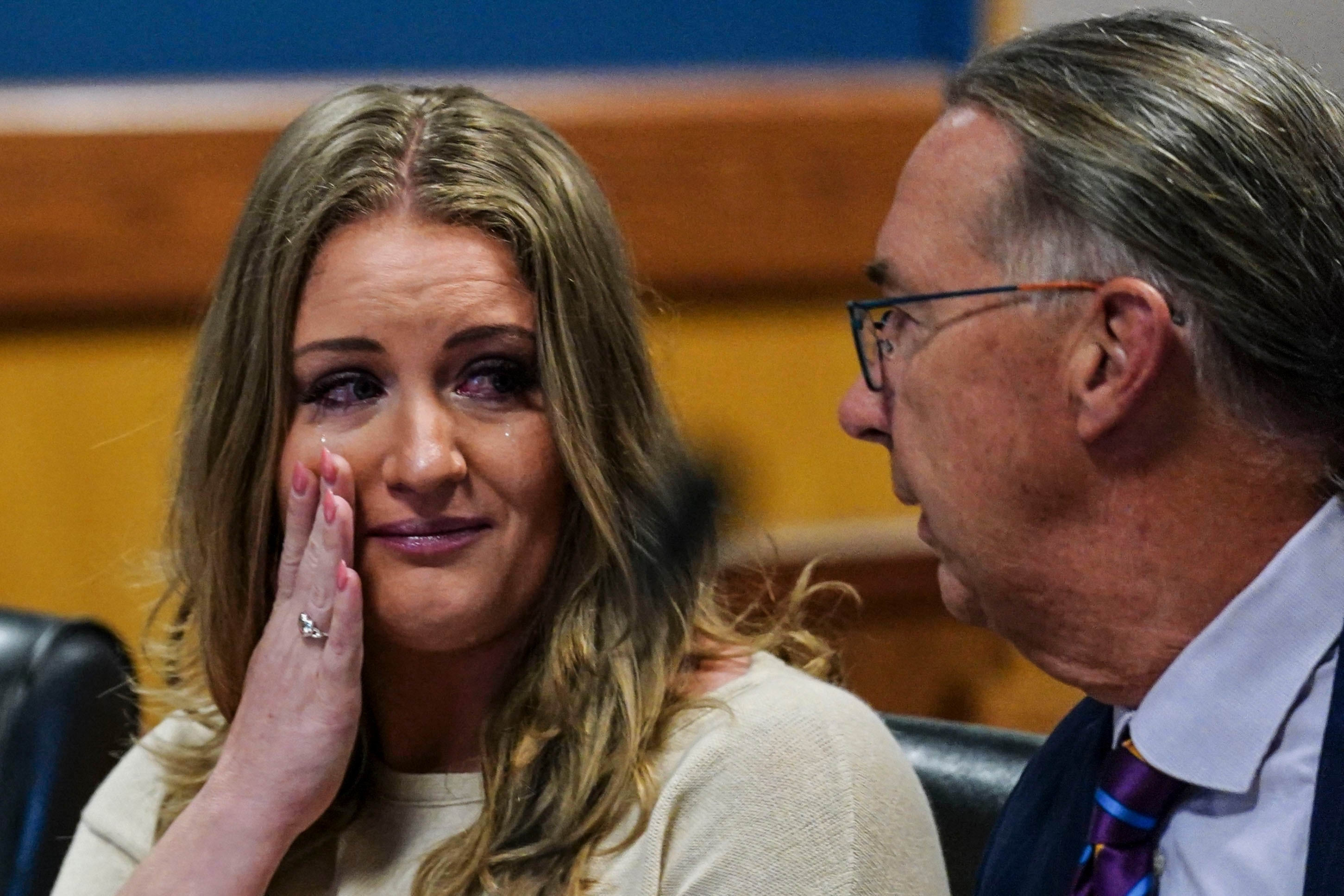 Jenna Ellis, pictured speaking to her attorney after reaching a plea agreement with prosecutors investigating an election interference scheme in Georgia in 2023, has agreed to cooperate in a similar case in Arizona.