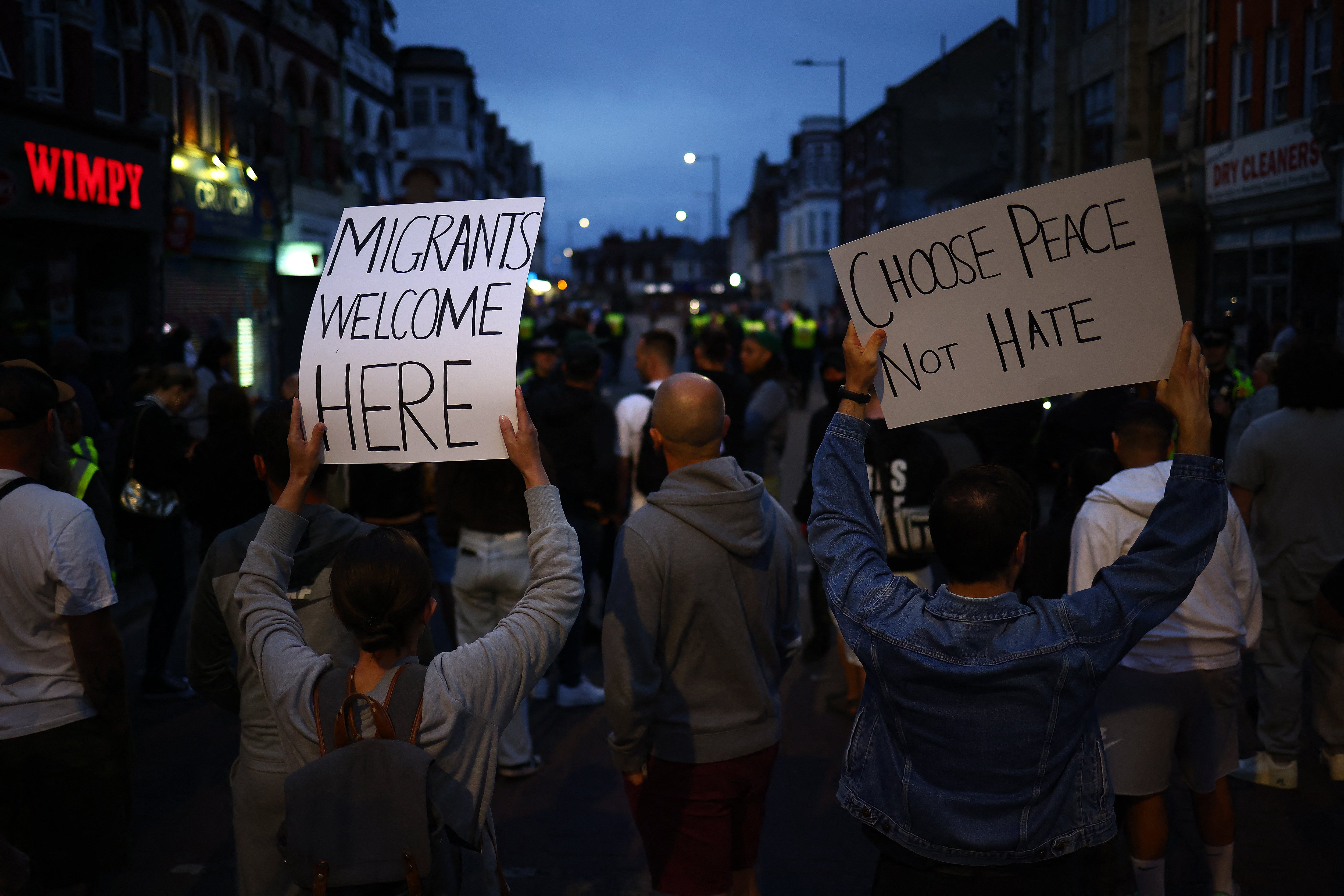 People hold anti-racism placards during a counter-demonstration against far-right activists