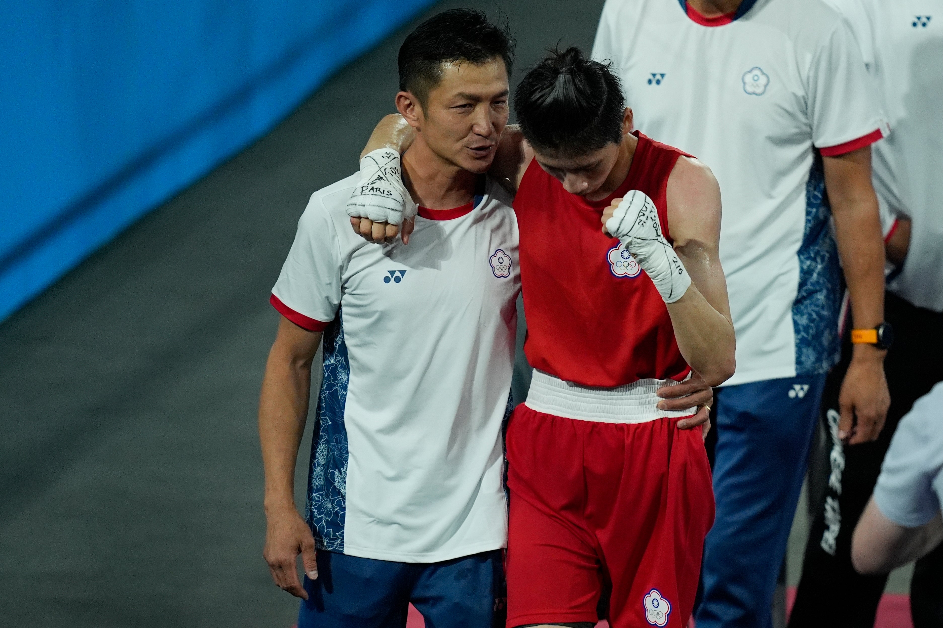 Taiwan's Lin Yu-ting celebrates with a coach after defeating Turkey's Esra Yildiz