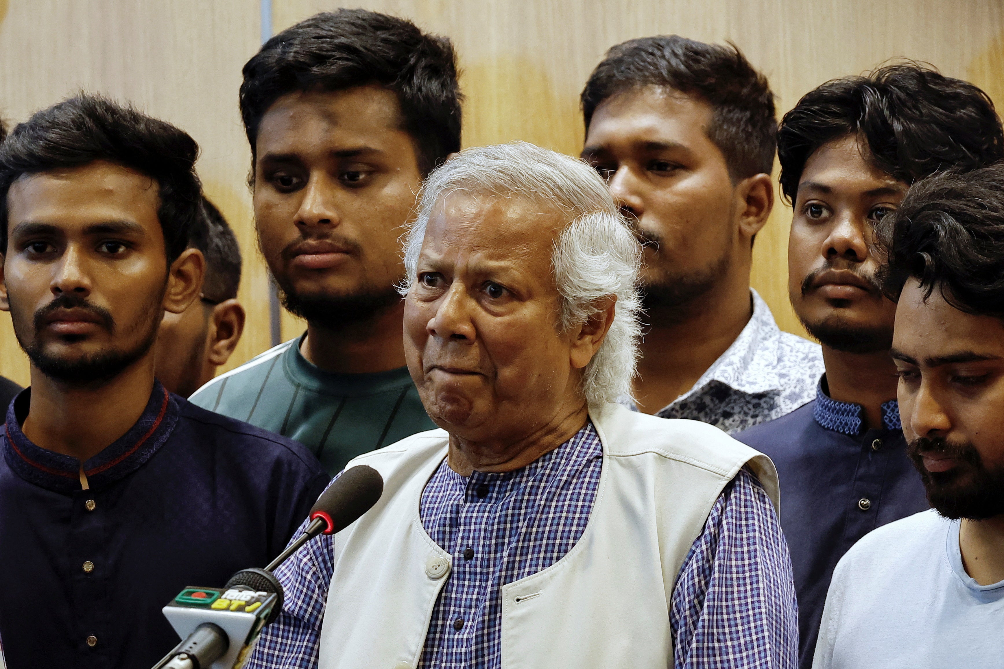 Muhammad Yunus speaks to reporters after arriving in Bangladesh