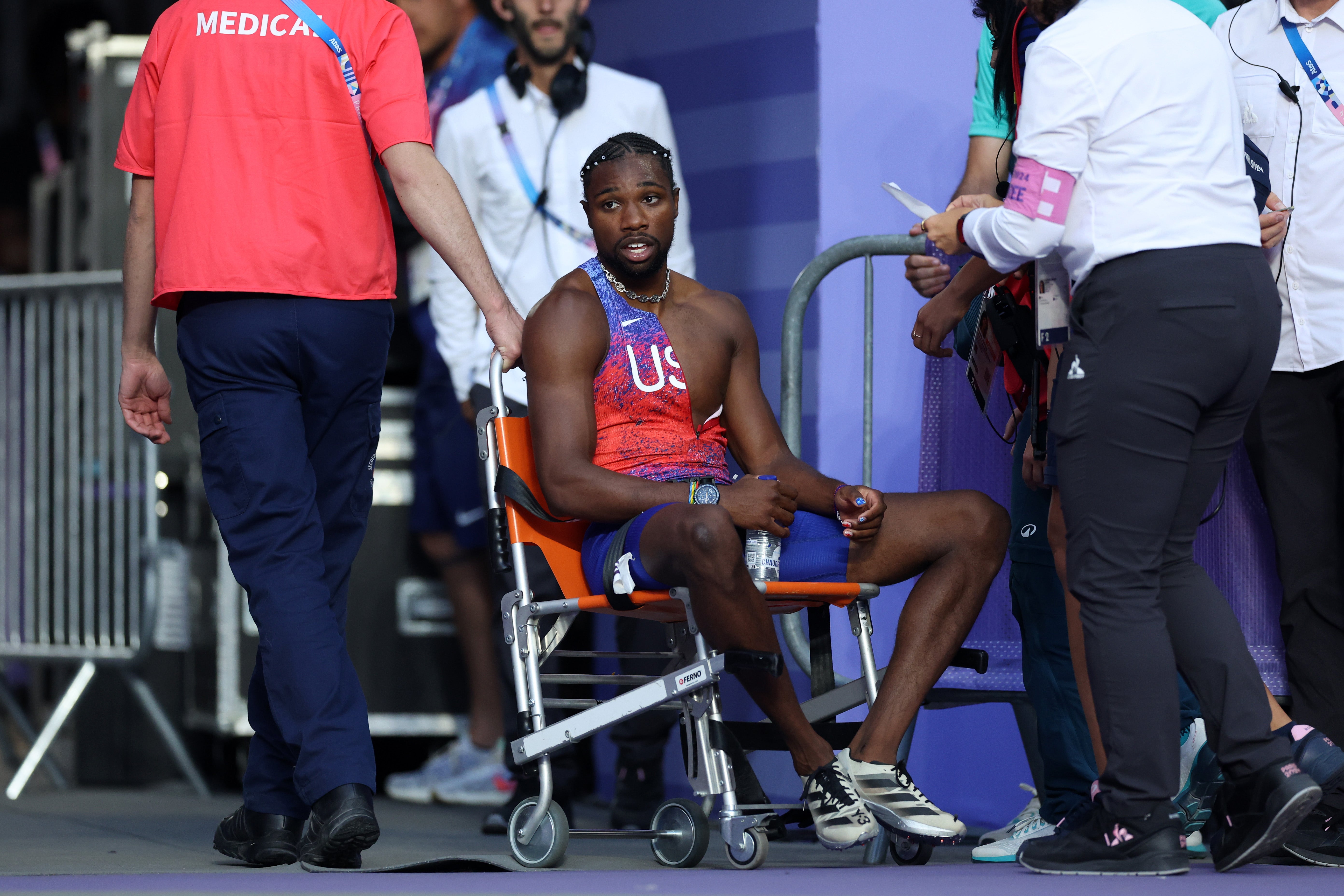 Noah Lyles leaves Olympic track in wheelchair after winning 200m bronze after contracting Covid-19