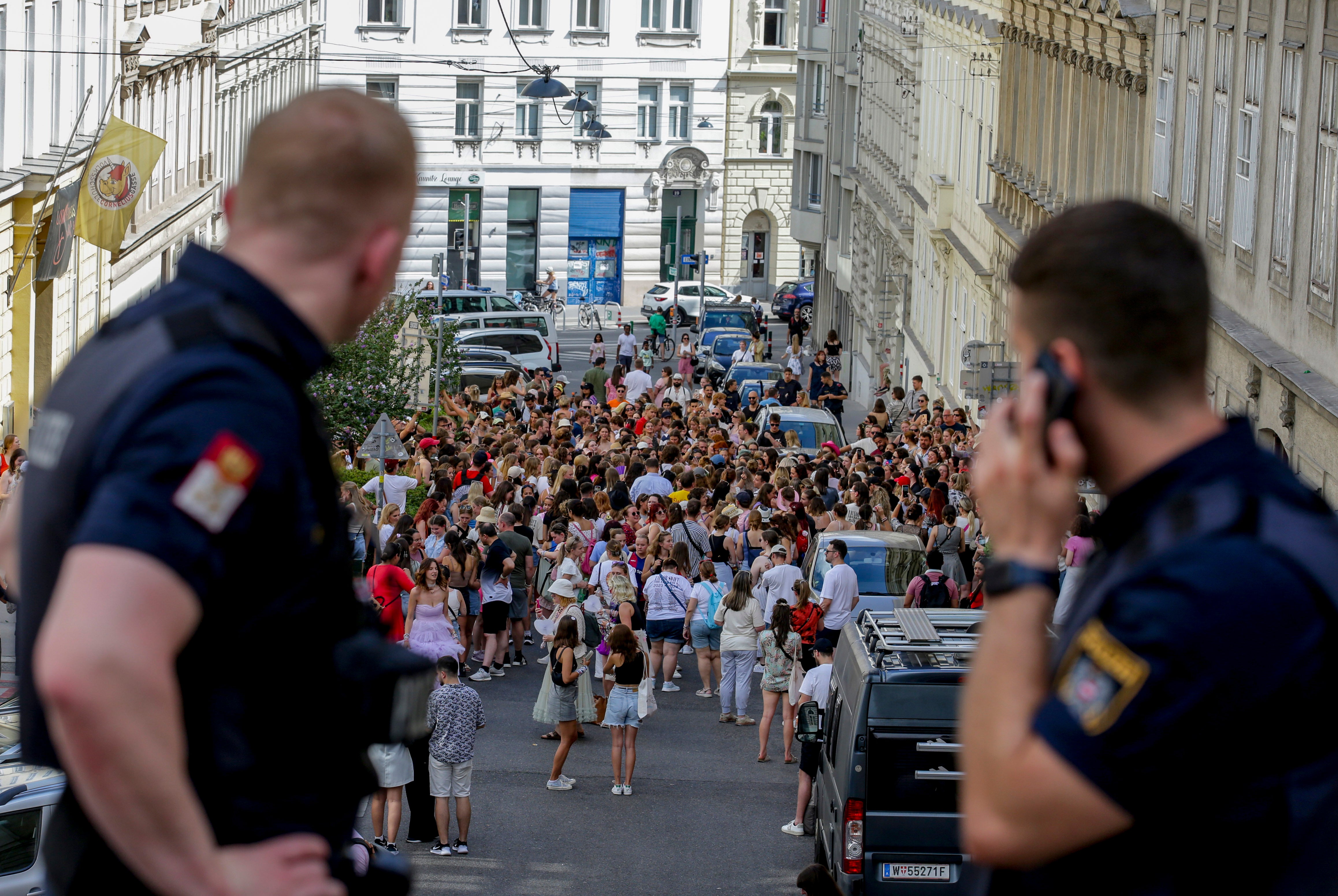 Austrian police officers watch Swift fans gathering in the city centre in Vienna