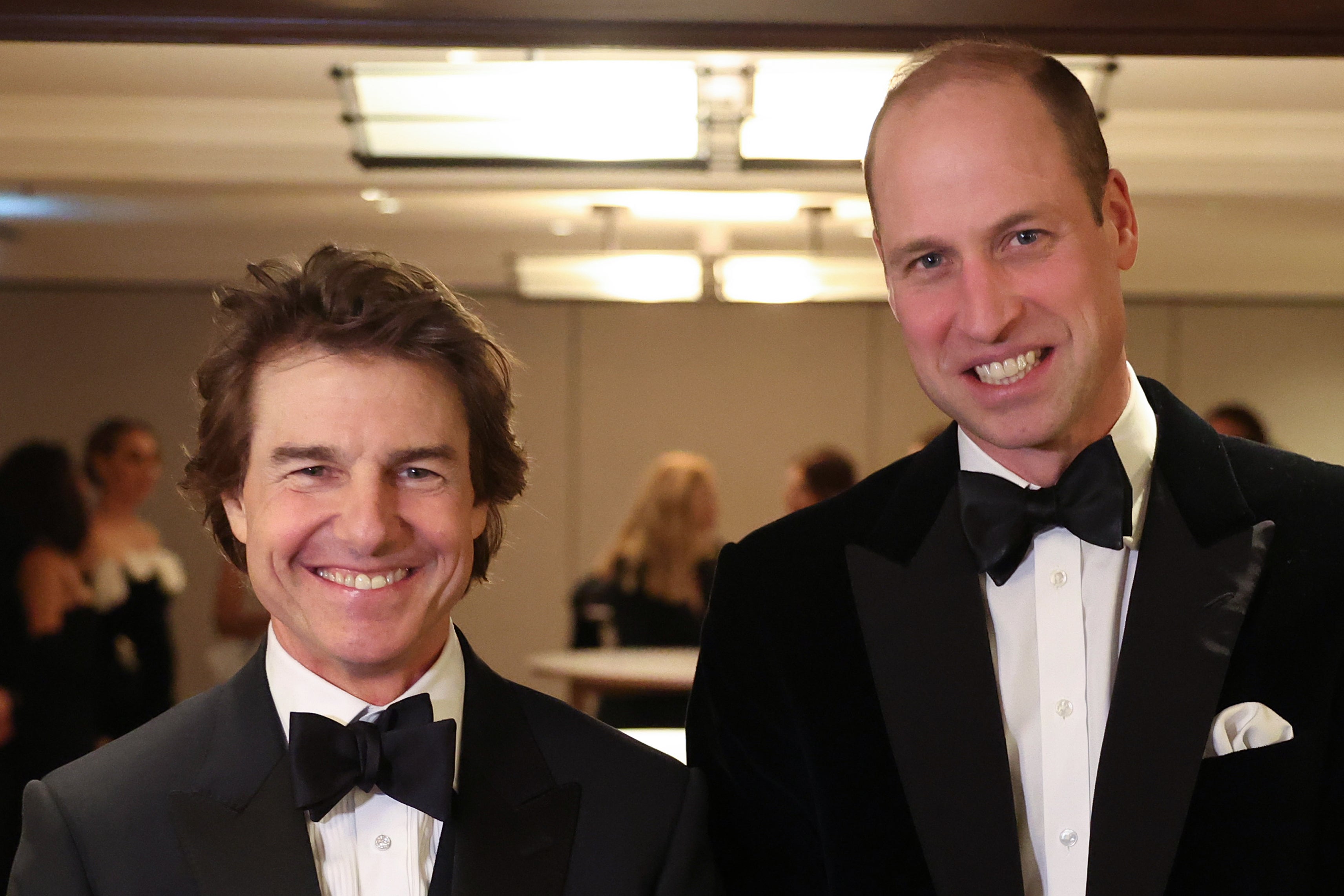 Gala guys: Cruise poses alongside Prince William at a charity event in February