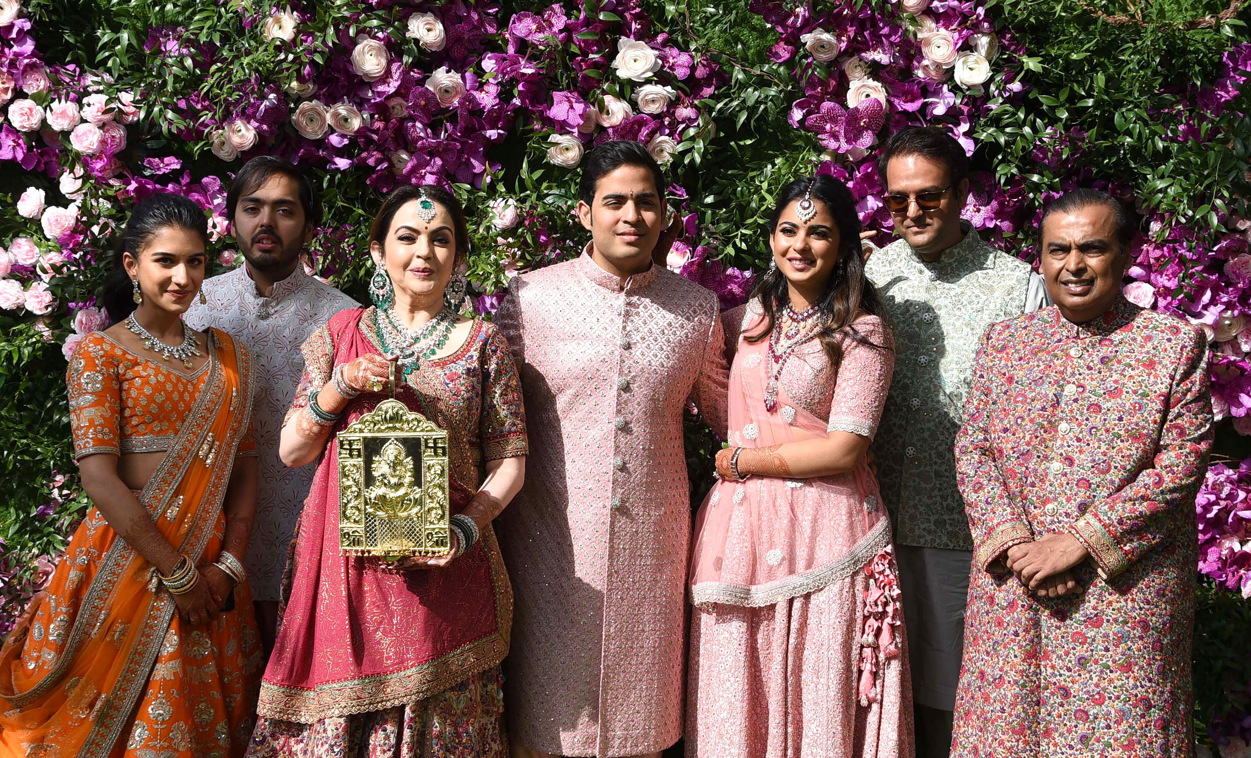 Mukesh Ambani (right) with his wife Nita Ambani (third from left) and children at the wedding ceremony of oldest son Akash in 2019