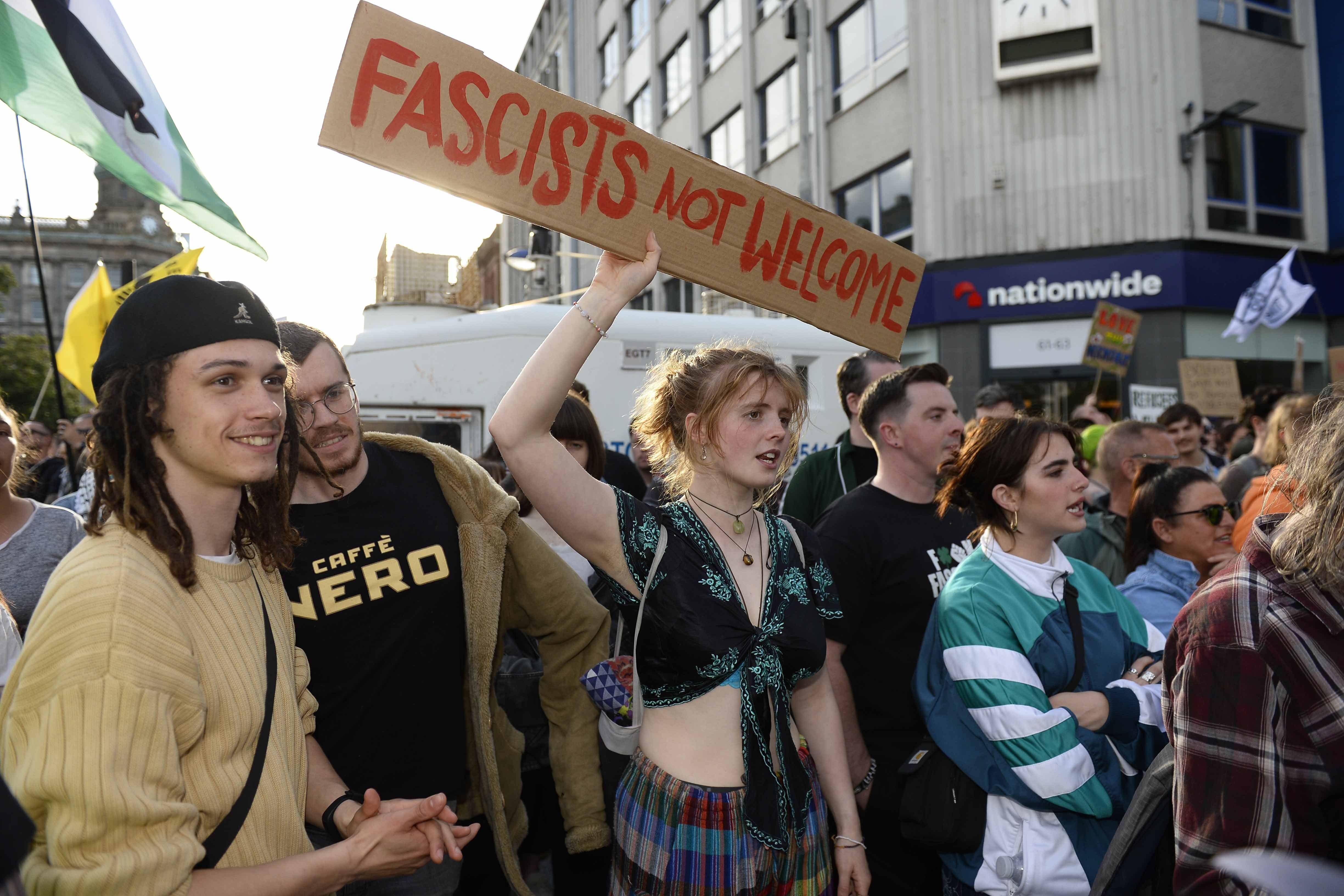 People talking part in a counter protest against the anti-immigration demonstration in Belfast city centre on Friday (PA)