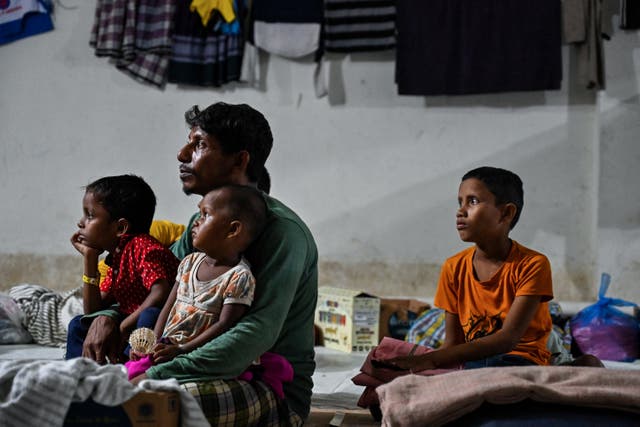 <p>Rohingya refugees gather at a temporary shelter in the basement of a government building in Banda Aceh </p>