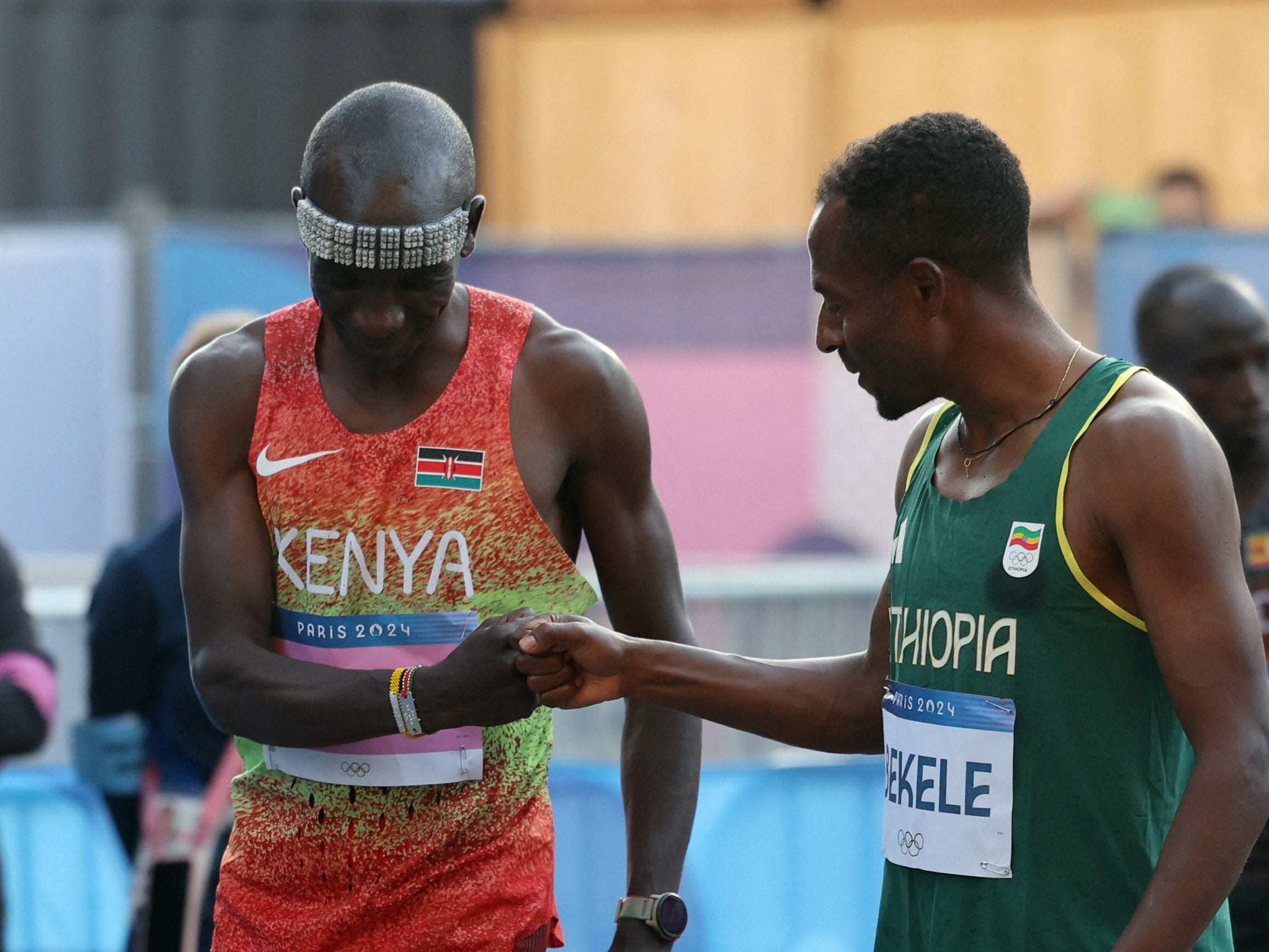 Eliud Kipchoge of Kenya bumps fists with Kenenisa Bekele of Ethiopia before the race