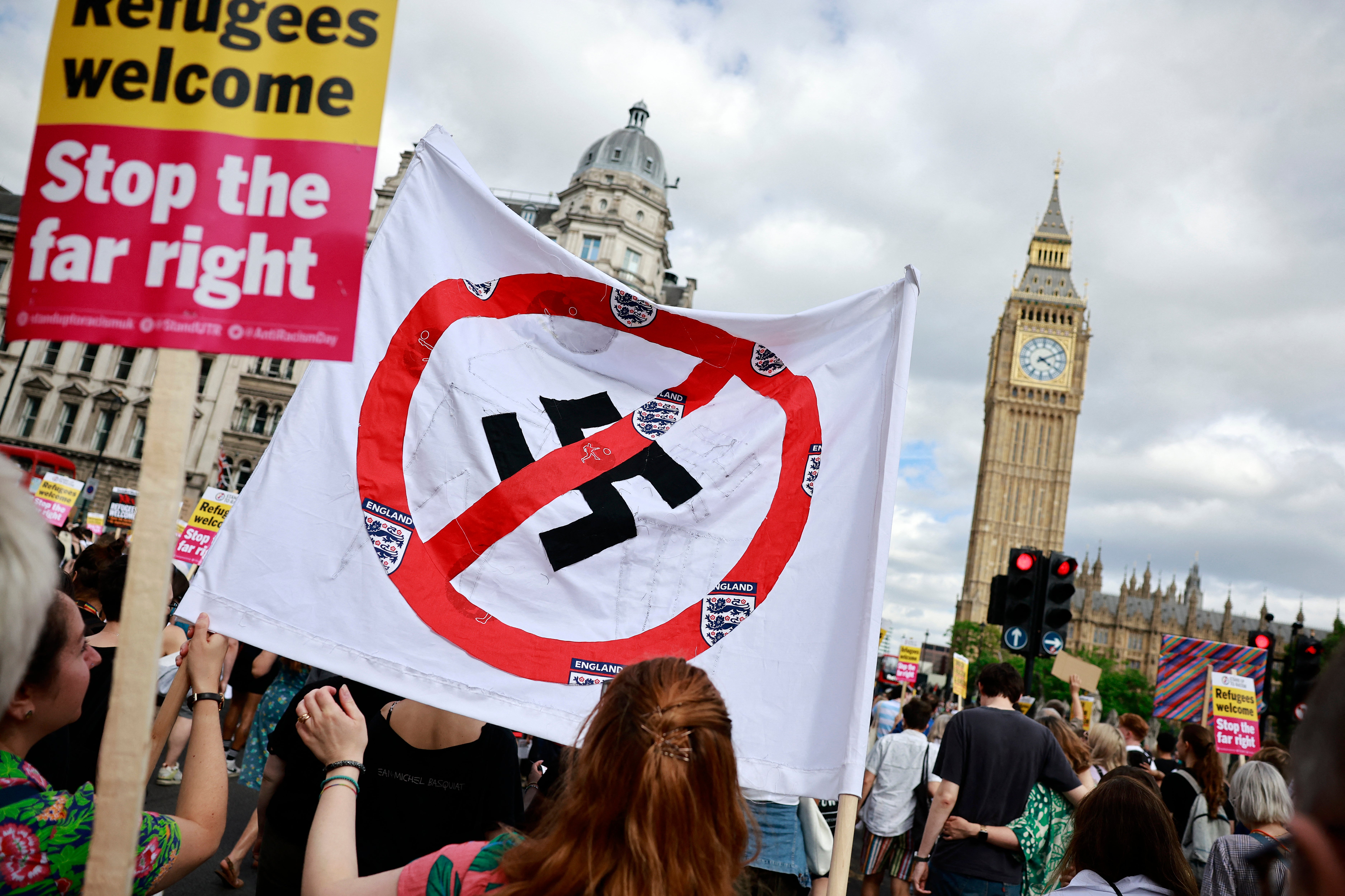 People hold anti-fascist banners as they participate in a "Stop the Far-right" march to Westminster (Photo by BENJAMIN CREMEL / AFP) (Photo by BENJAMIN CREMEL/AFP via Getty Images)