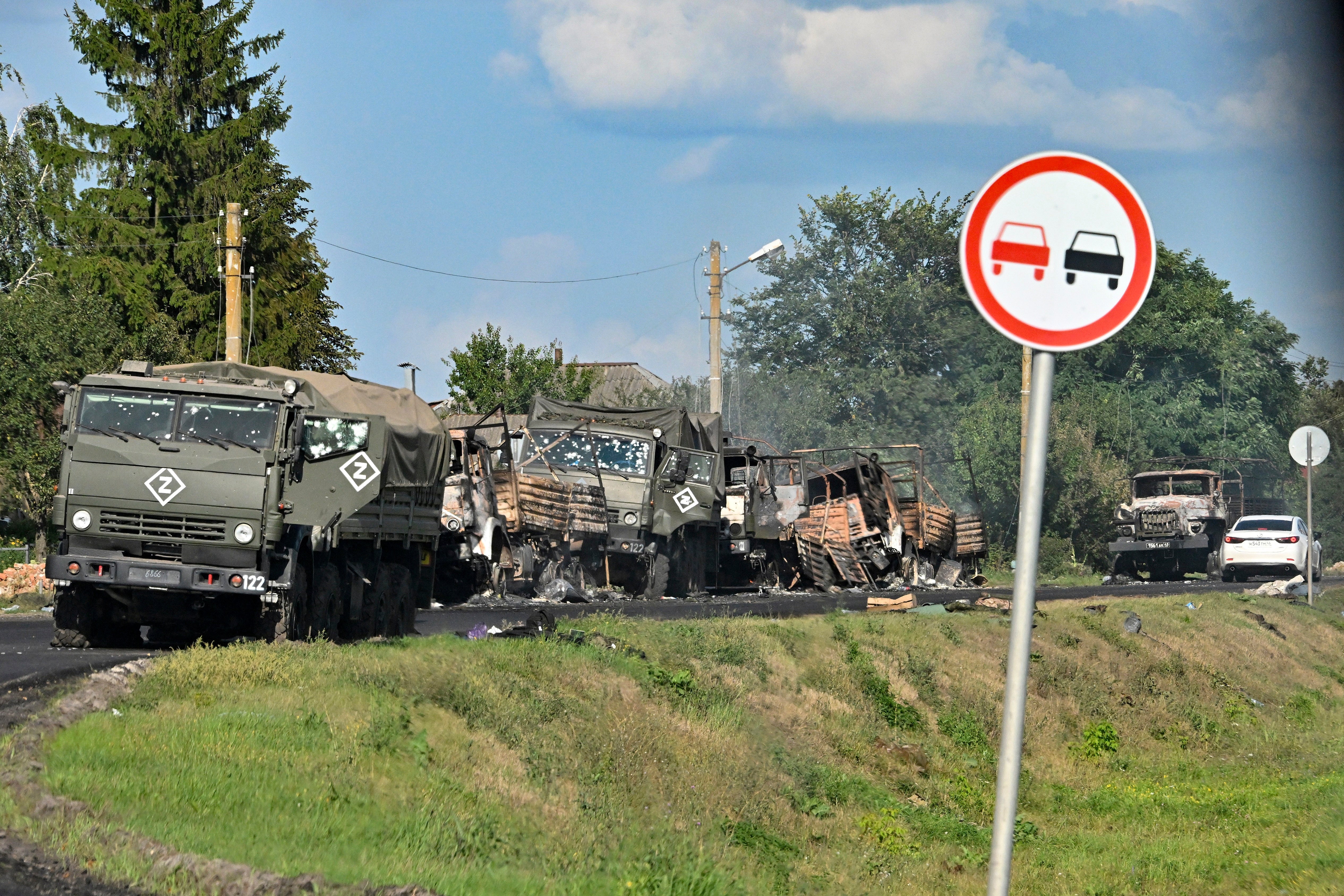 A column of Russian army trucks damaged by shelling on the highway in the Sudzhansky district, Kursk region of Russia, on Friday