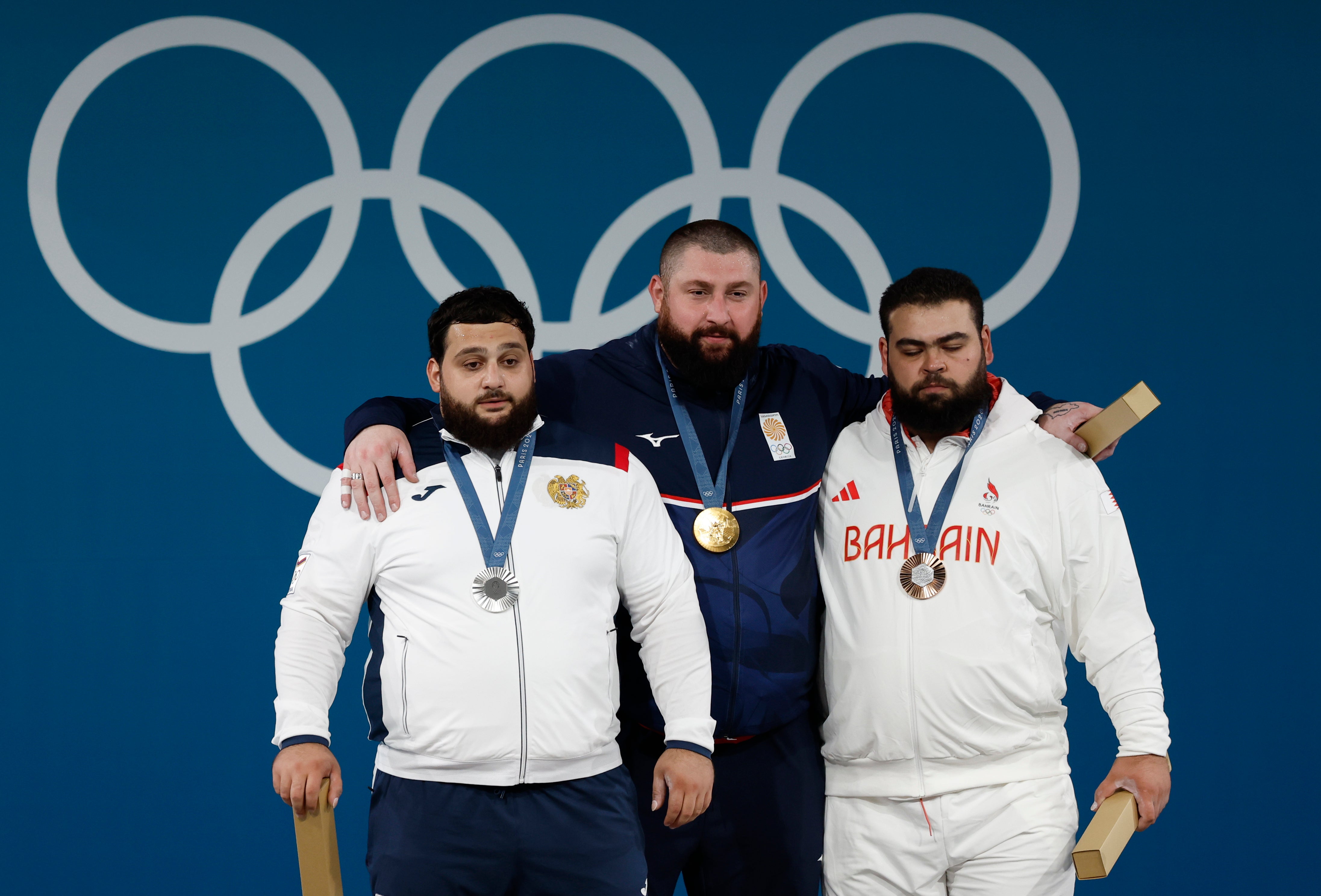 Lasha Talakhadze of Georgia with Silver medalist Varazdat Lalayan of Armenia and bronze medalist Gor Minasyan of Bahrein