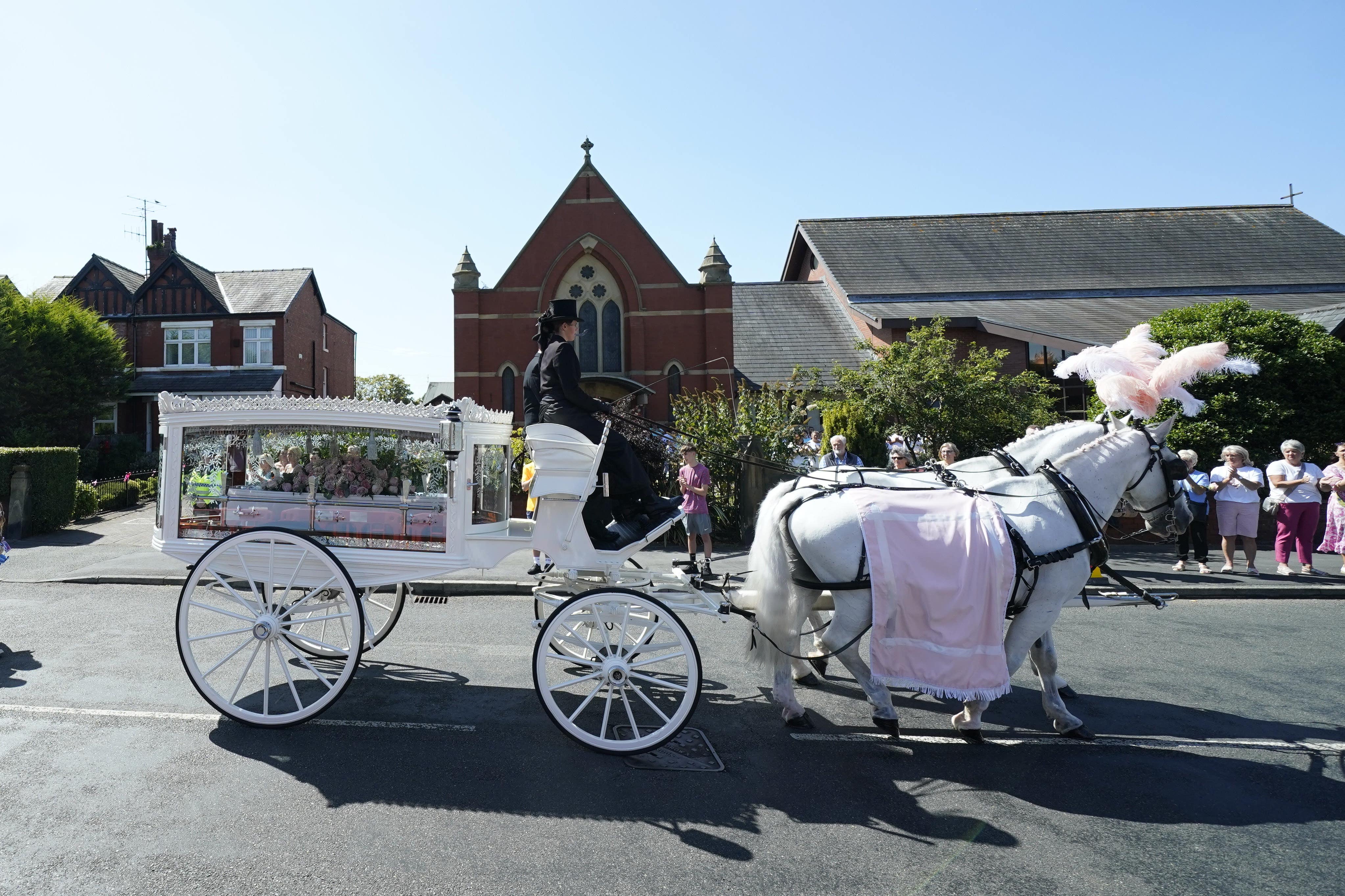 The horse-drawn carriage carrying the coffin Alice