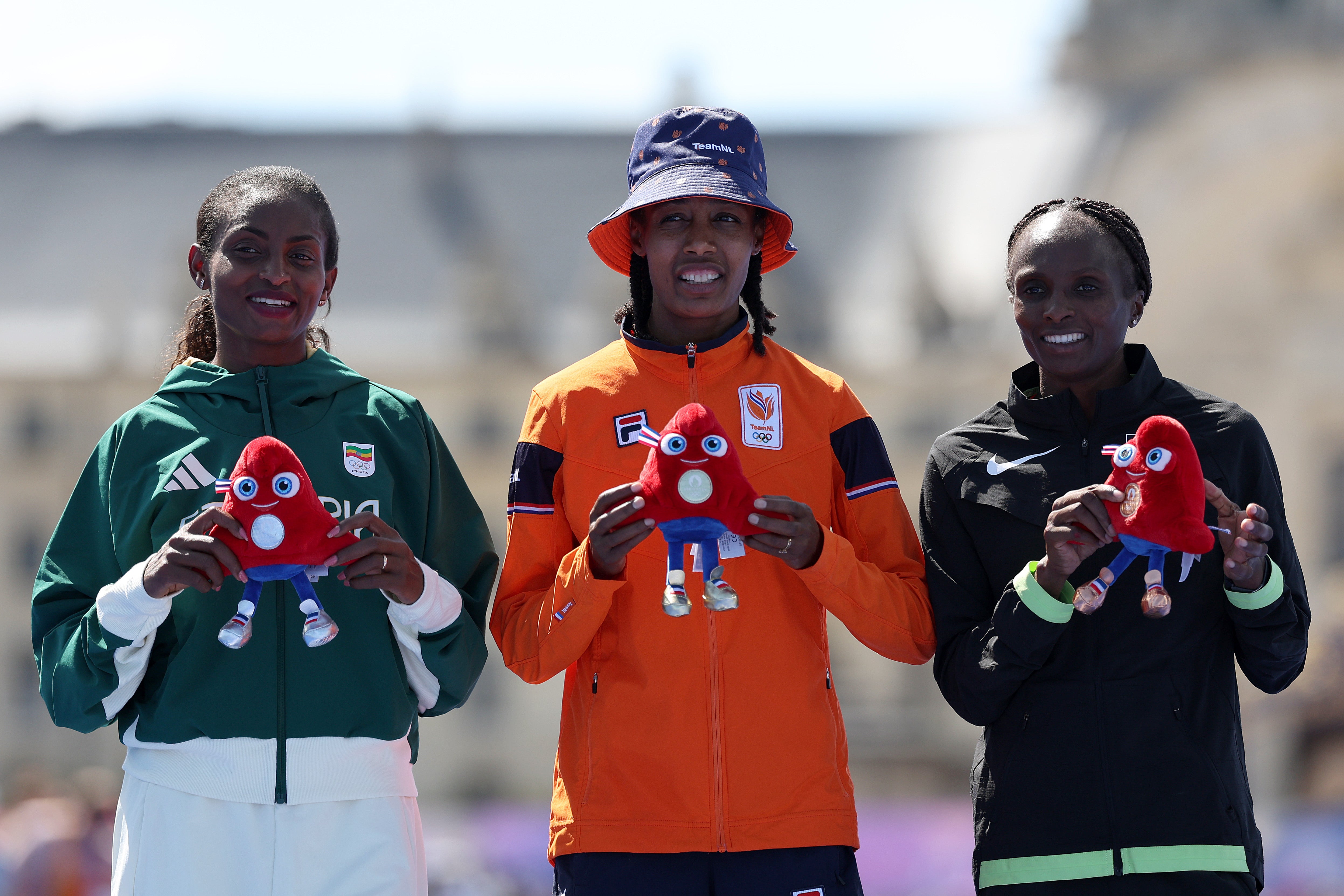 Gold medalist Sifan Hassan of Team Netherlands (C), Silver medalist Tigst Assefa of Team Ethiopia (L) and Bronze Hellen Obiri of Team Kenya (R)