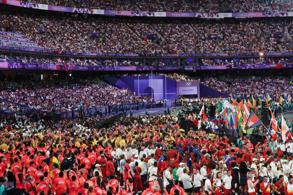 Athletes of various nations gather inside the Stade de France during the closing ceremony of the Paris Olympics on Friday