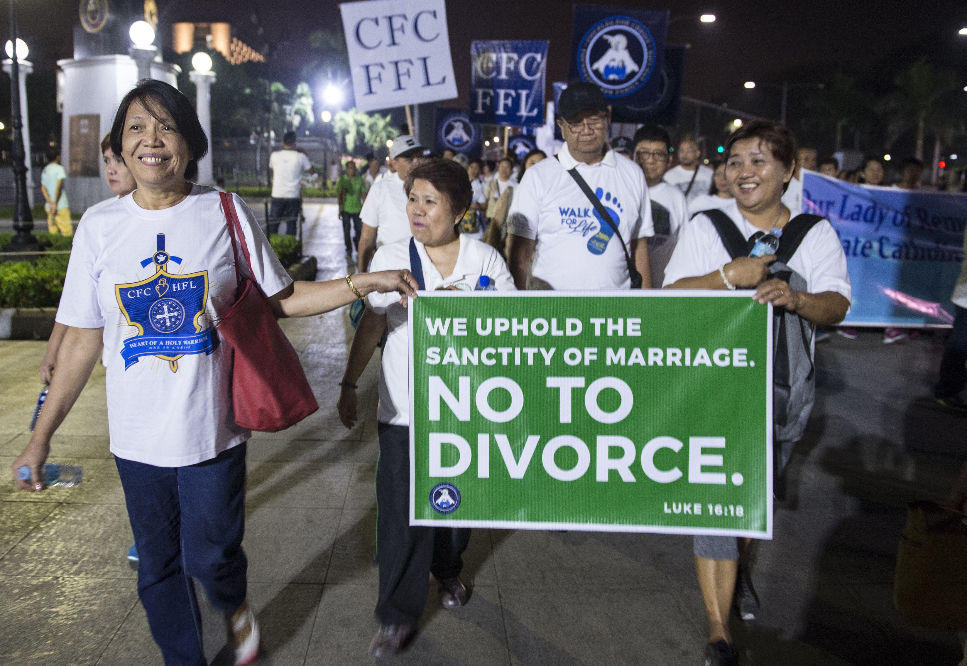 Philippine Catholic faithful hold a banner as they take part in a ‘Walk for Life’ protest in Manila in 2018