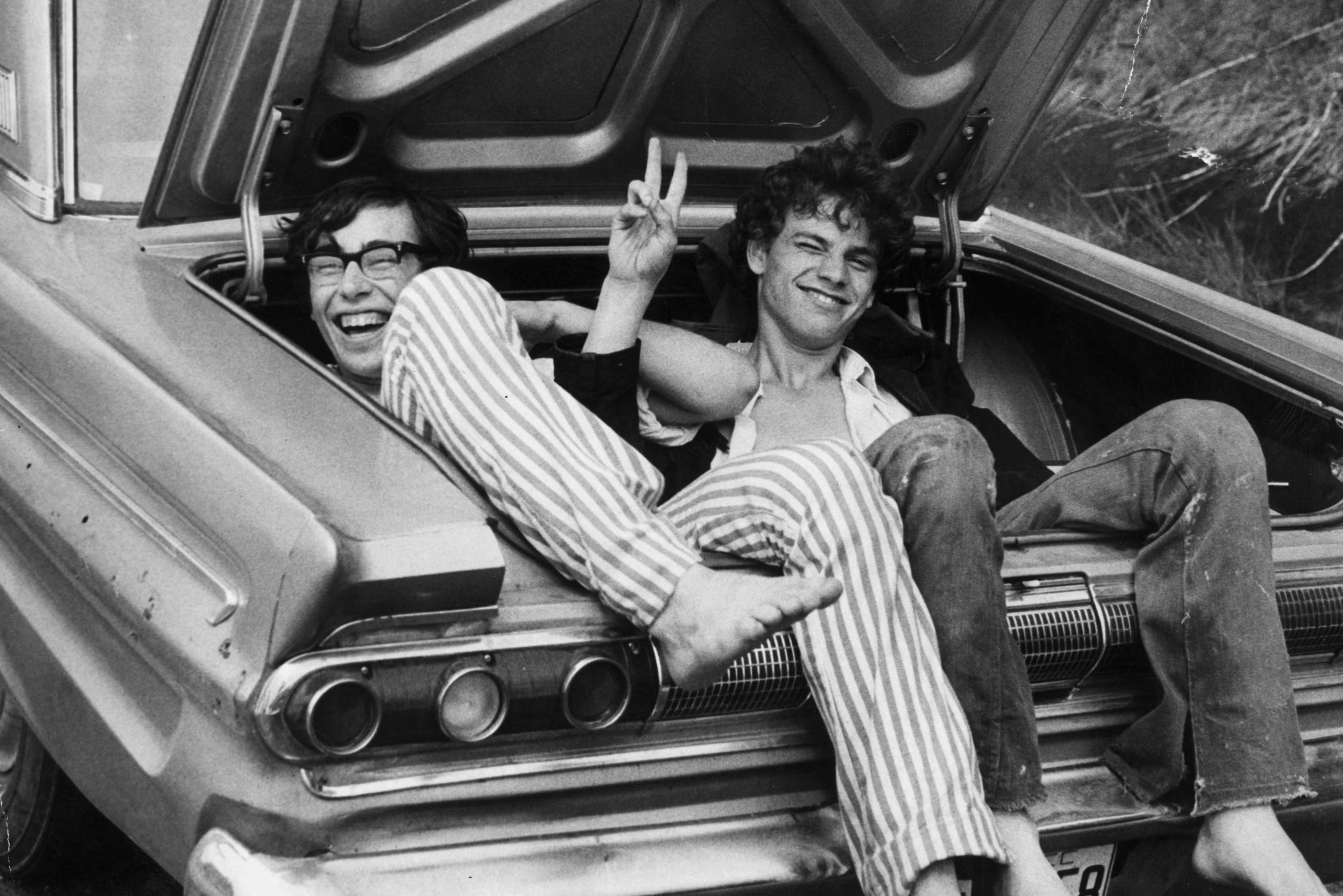 Two young music fans hitch a lift home from Woodstock Music and Arts Fair, August 1969