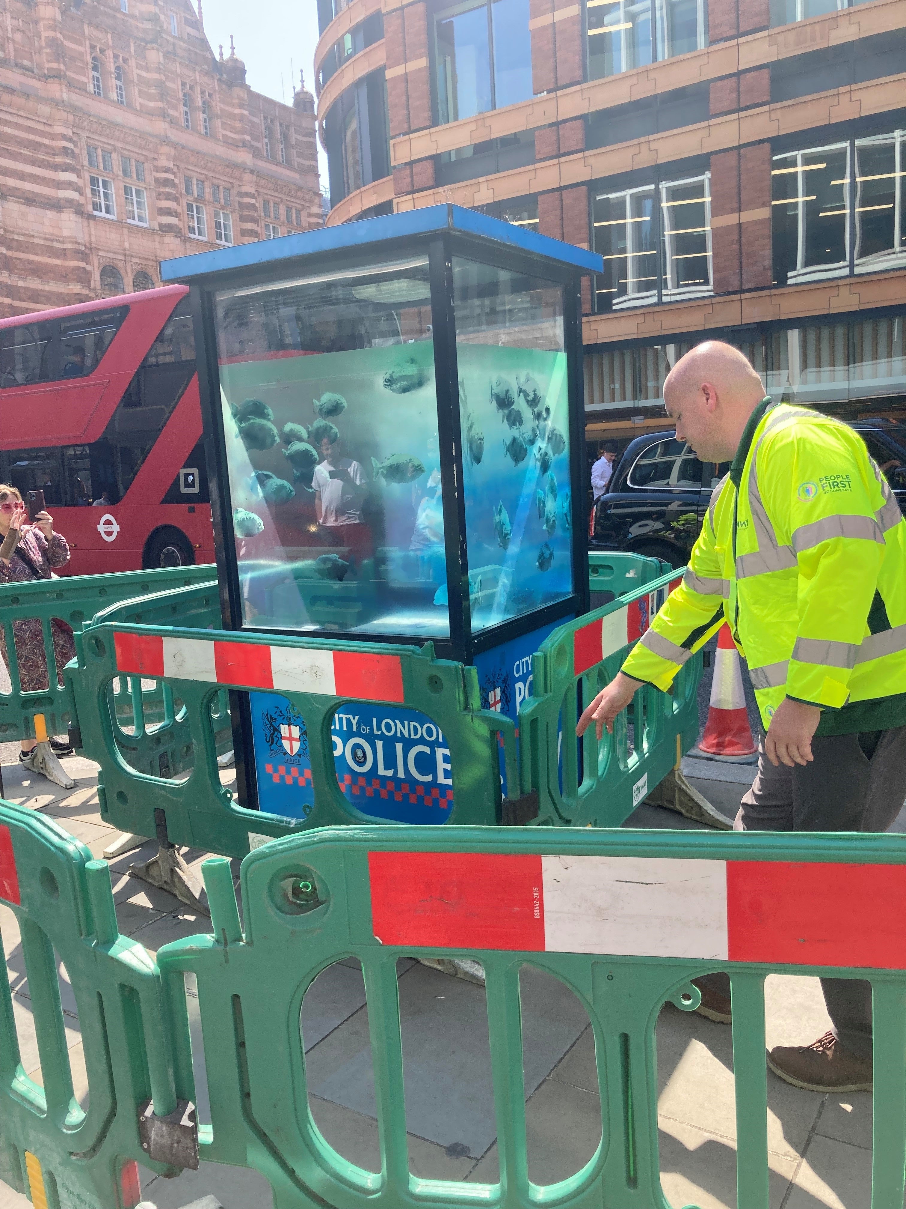 A new design of swimming fish by Banksy, which appeared on a police box in the City of London is cordoned off