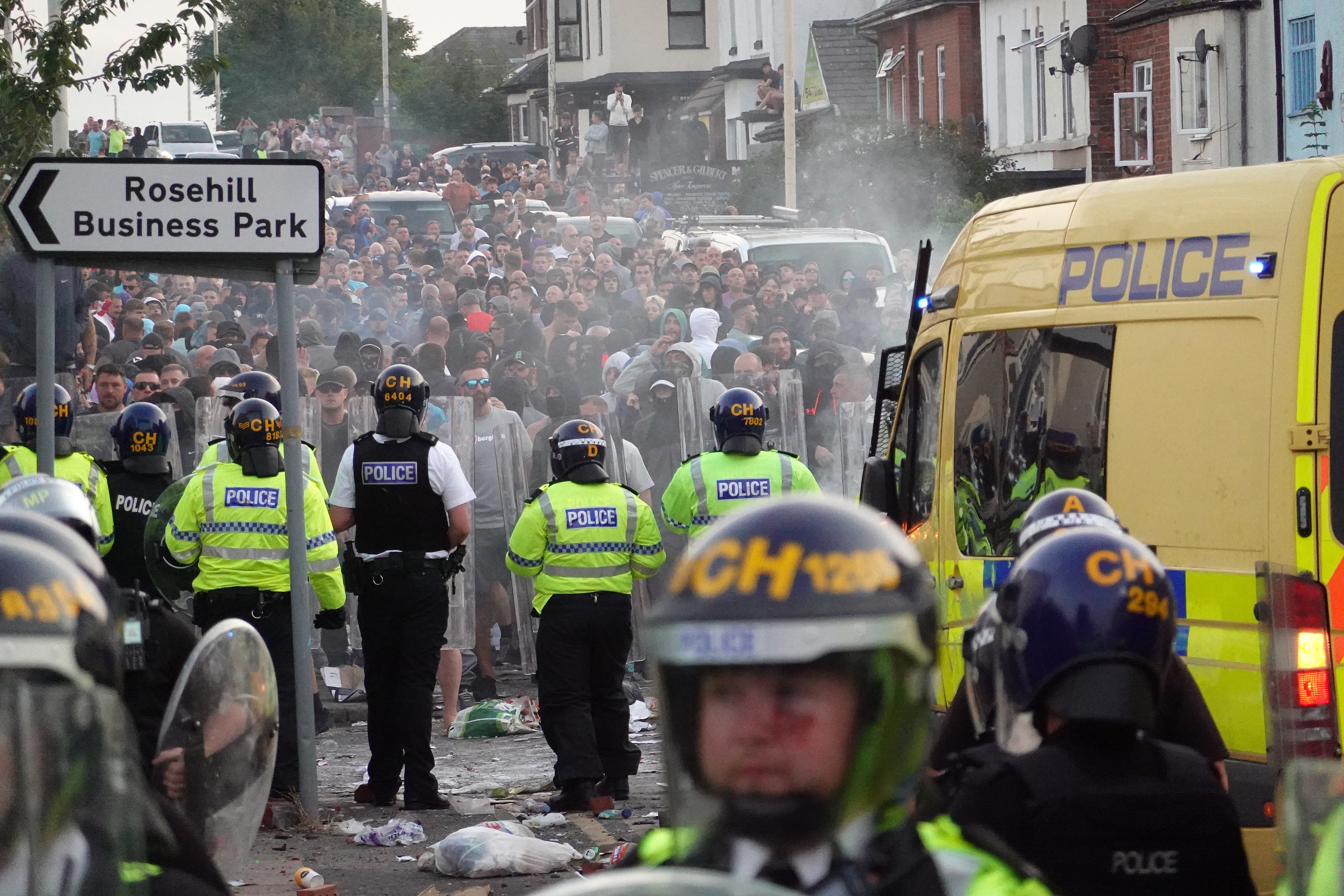 Riot police hold back protesters in Southport after three young girls were killed