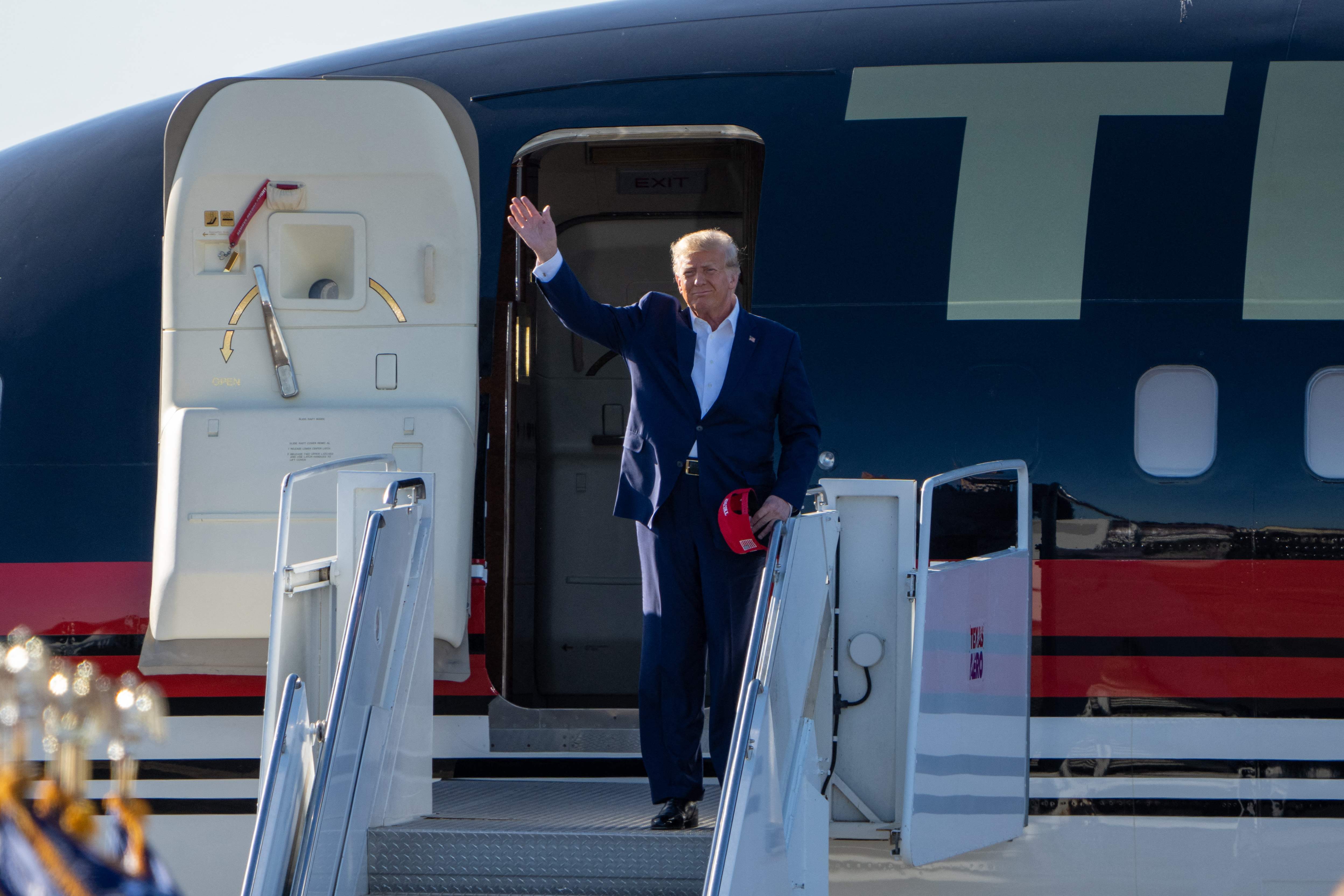 Republican nominee Donald Trump appears oustide Trump Force One in 2023. After his famed plane had mechanical difficulties over the weekend, Trump used a plane once owned by Jeffrey Epstein to travel to campaign events.