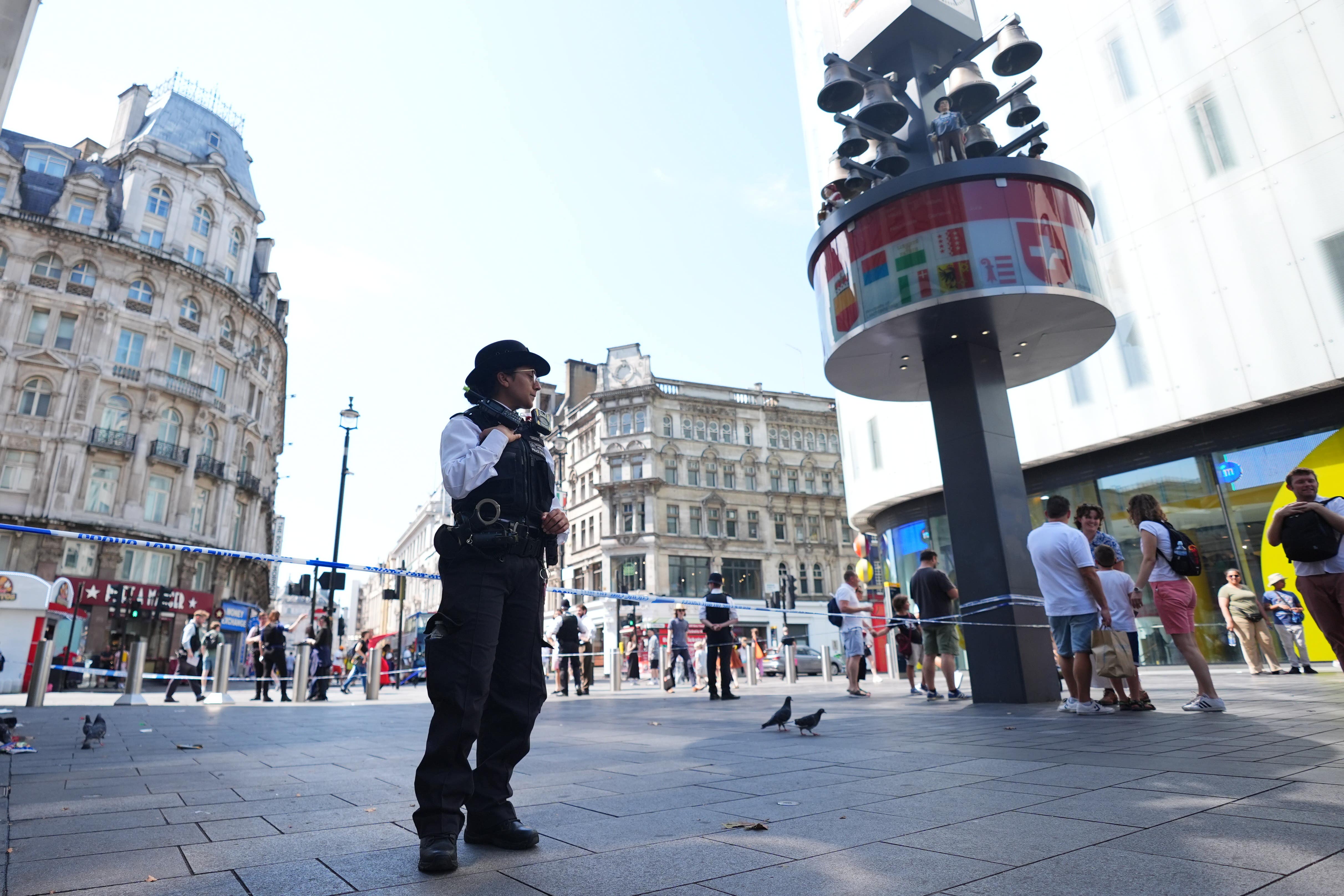 Police officers at the scene of the incident in Leicester Square (James Manning/PA)