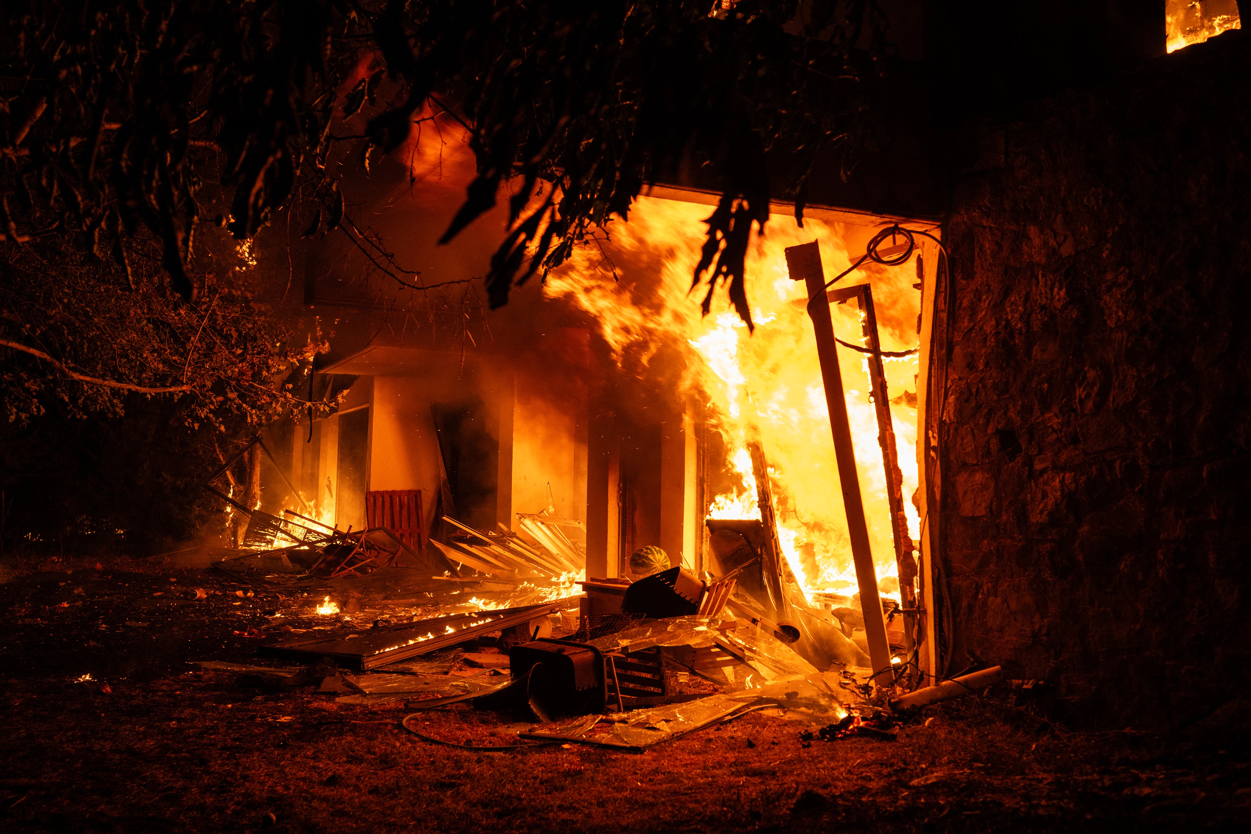 A house burns during a wildfire in Varnavas, north of Athens, on August 11, 2024