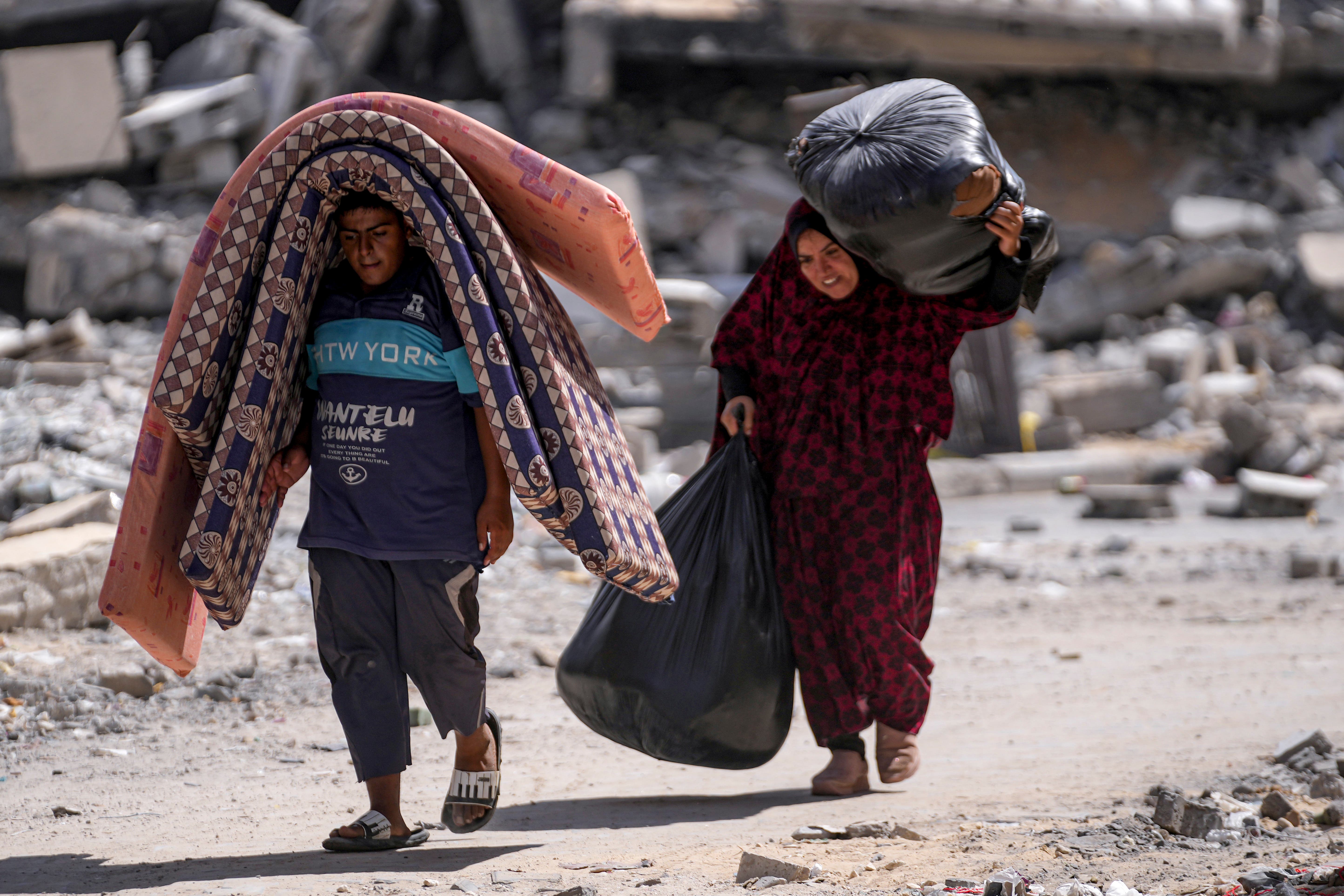 Palestinians displaced by the Israeli air and ground offensive on the Gaza Strip flee from Hamad City, following an evacuation order by the Israeli army to leave parts of the southern area of Khan Younis (Abdel Kareem Hana/AP)