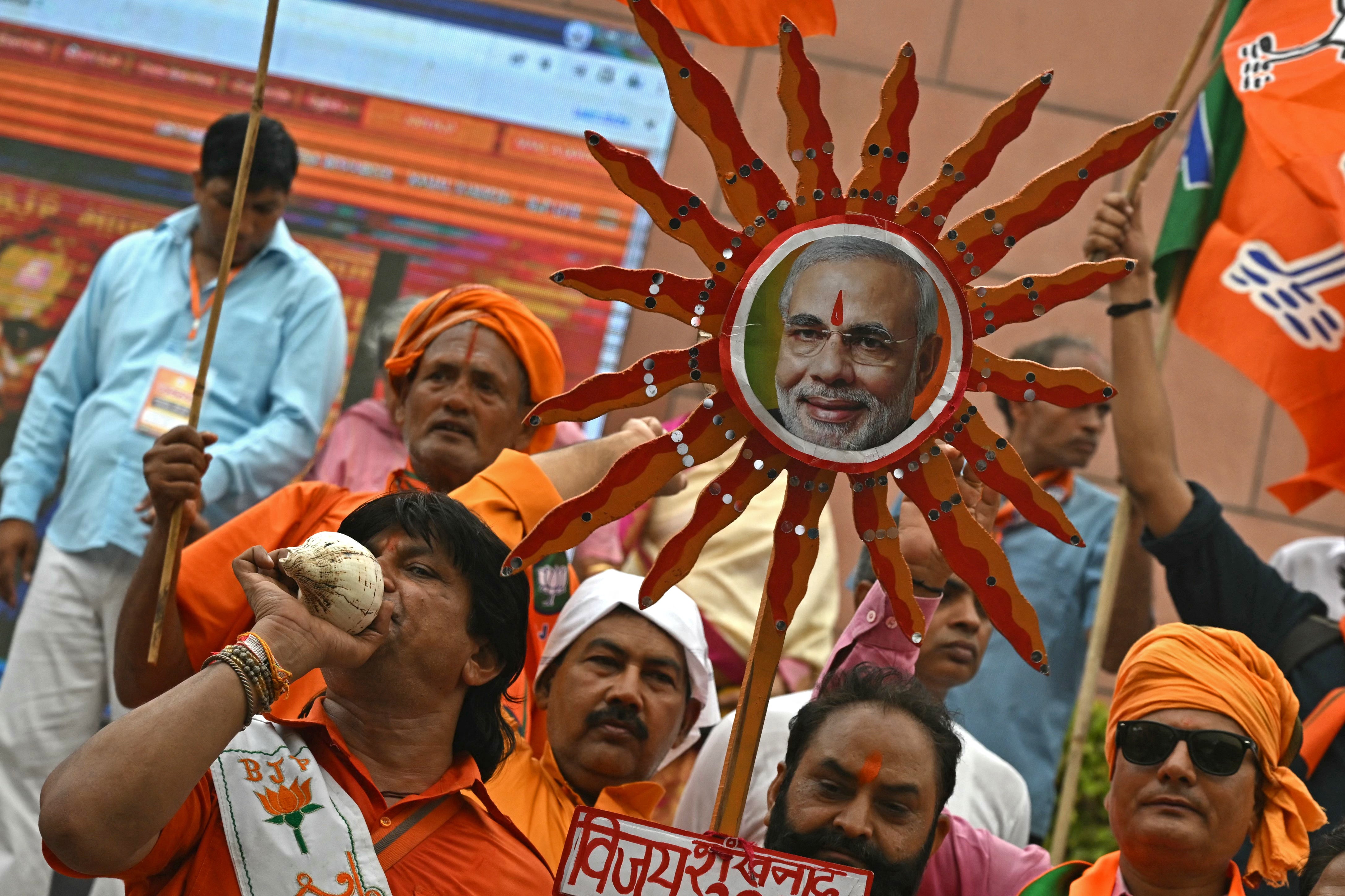 Supporters of Narendra Modi celebrate vote counting results for India’s general election at BJP headquarters in New Delhi