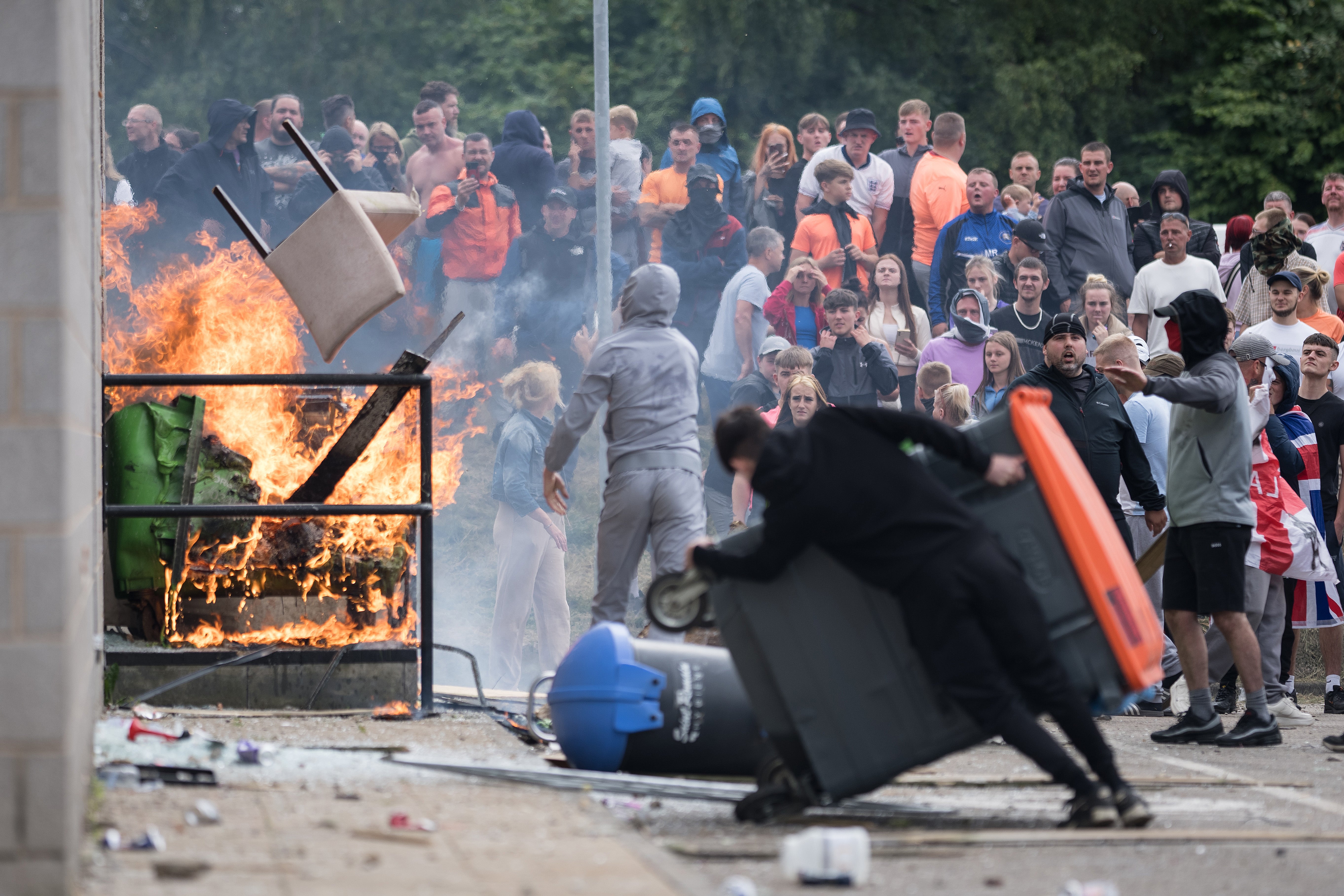 Anti-migration protesters attempt to enter the Holiday Inn Express Hotel, which was housing asylum seekers, on 4 August in Rotherham