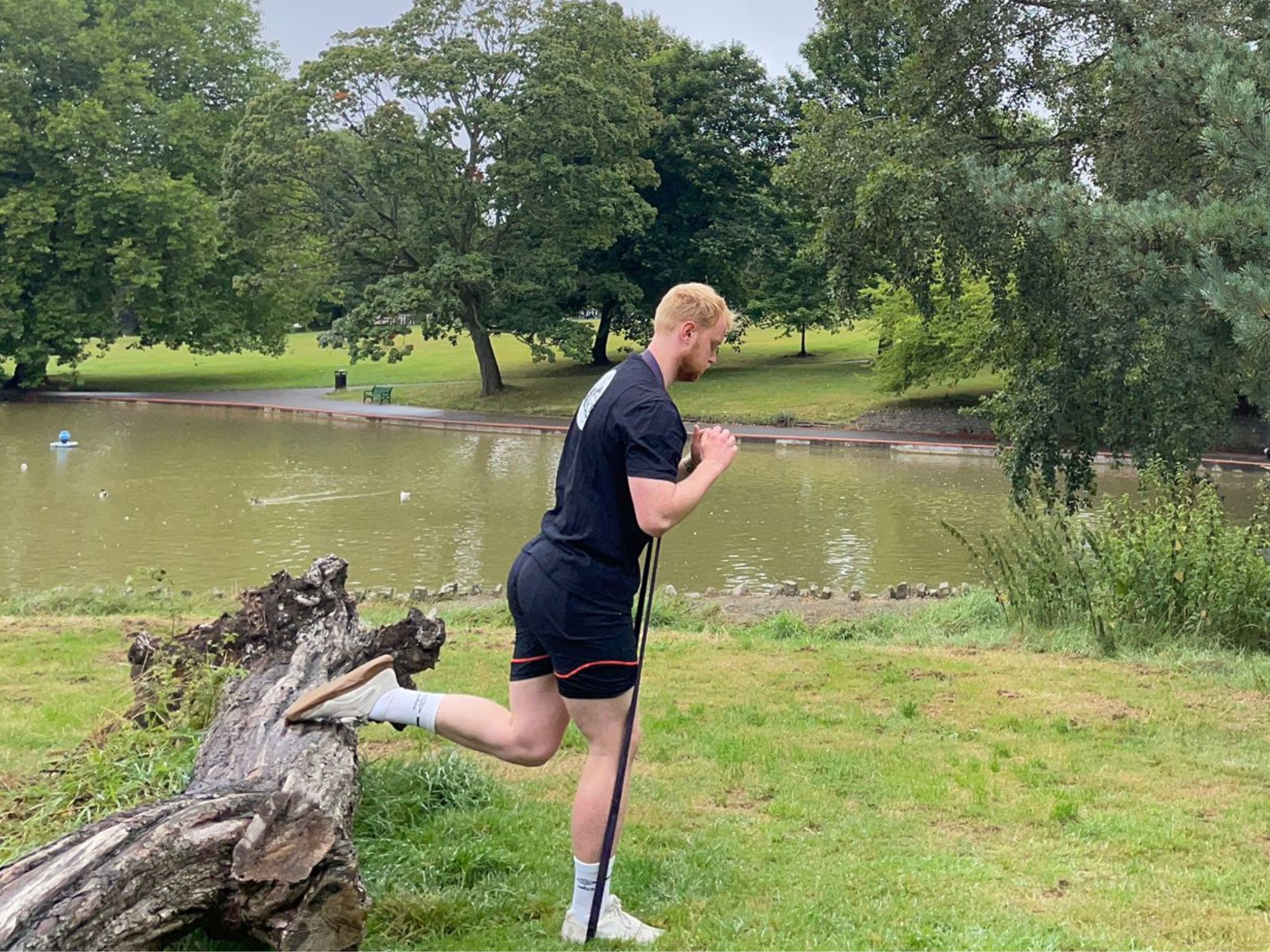 The Independent’s fitness writer Harry Bullmore performing a banded Bulgarian split squat in a park