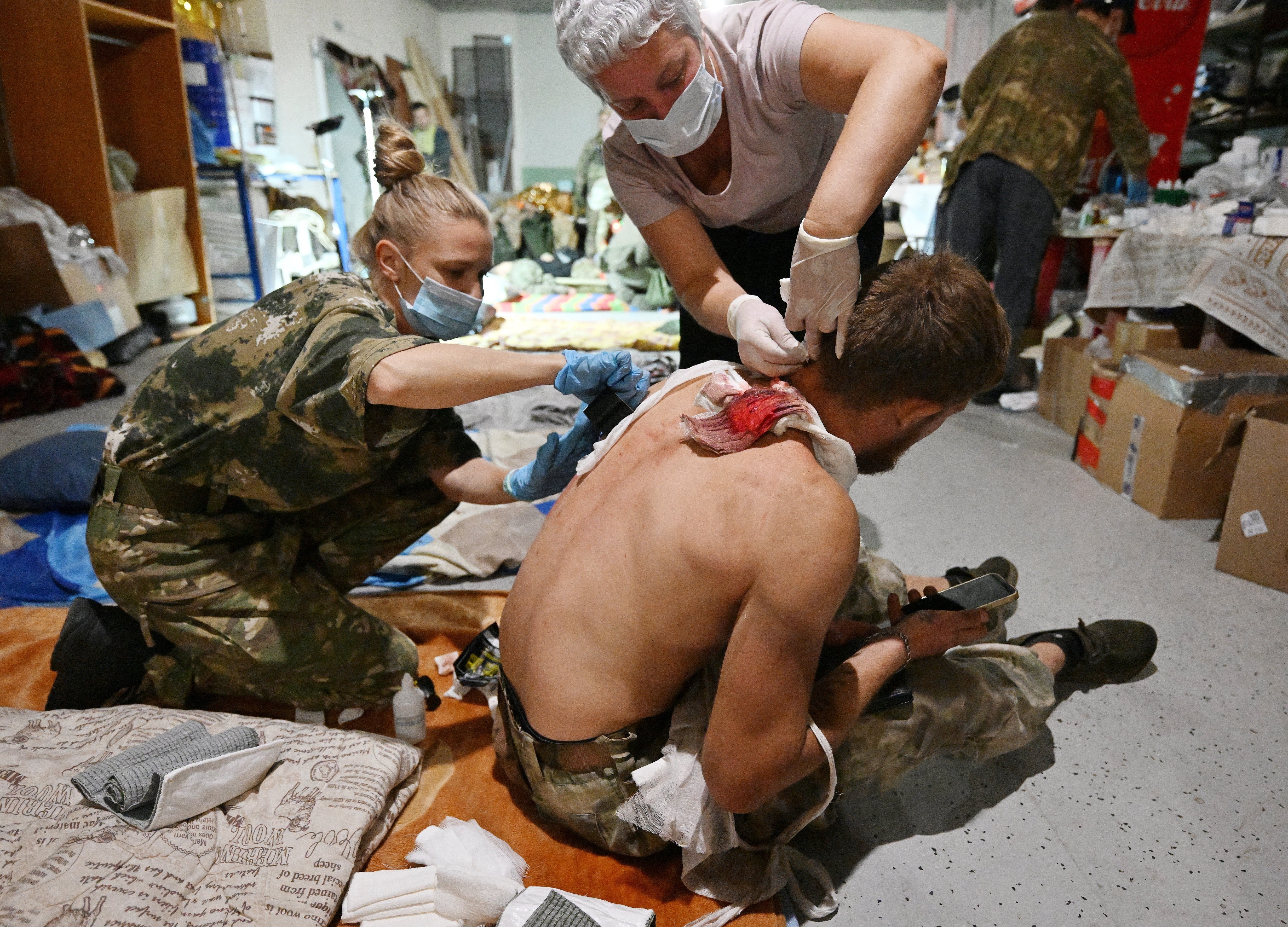 Medics dress the wounds of a man in a field hospital at an undisclosed location in Russia’s Kursk region