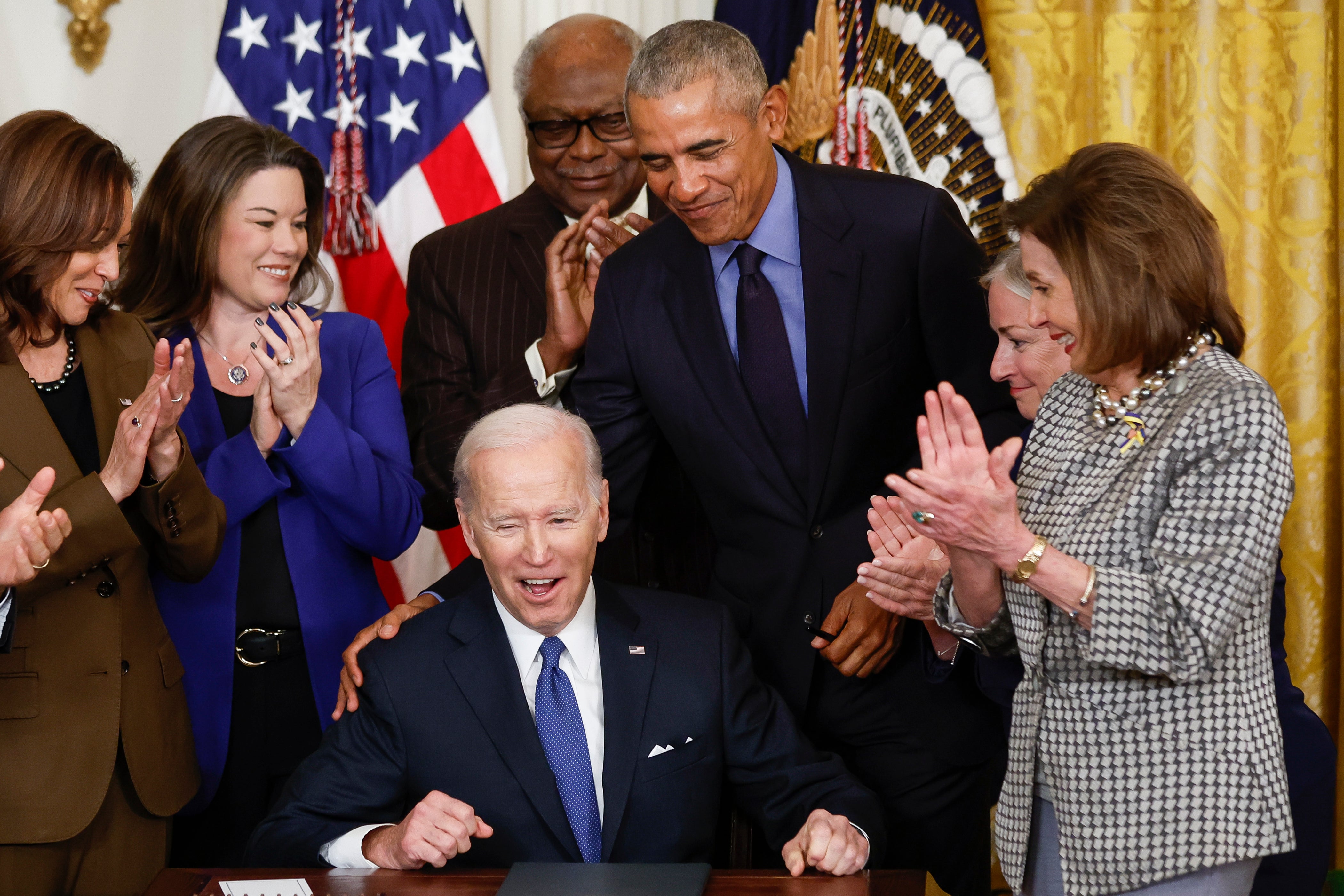 Barack Obama and Pelosi congratulate Biden in April 2022 as he signs an executive order to strengthen the 2010 Affordable Care Act, a landmark healthcare bill all three were heavily involved in passing