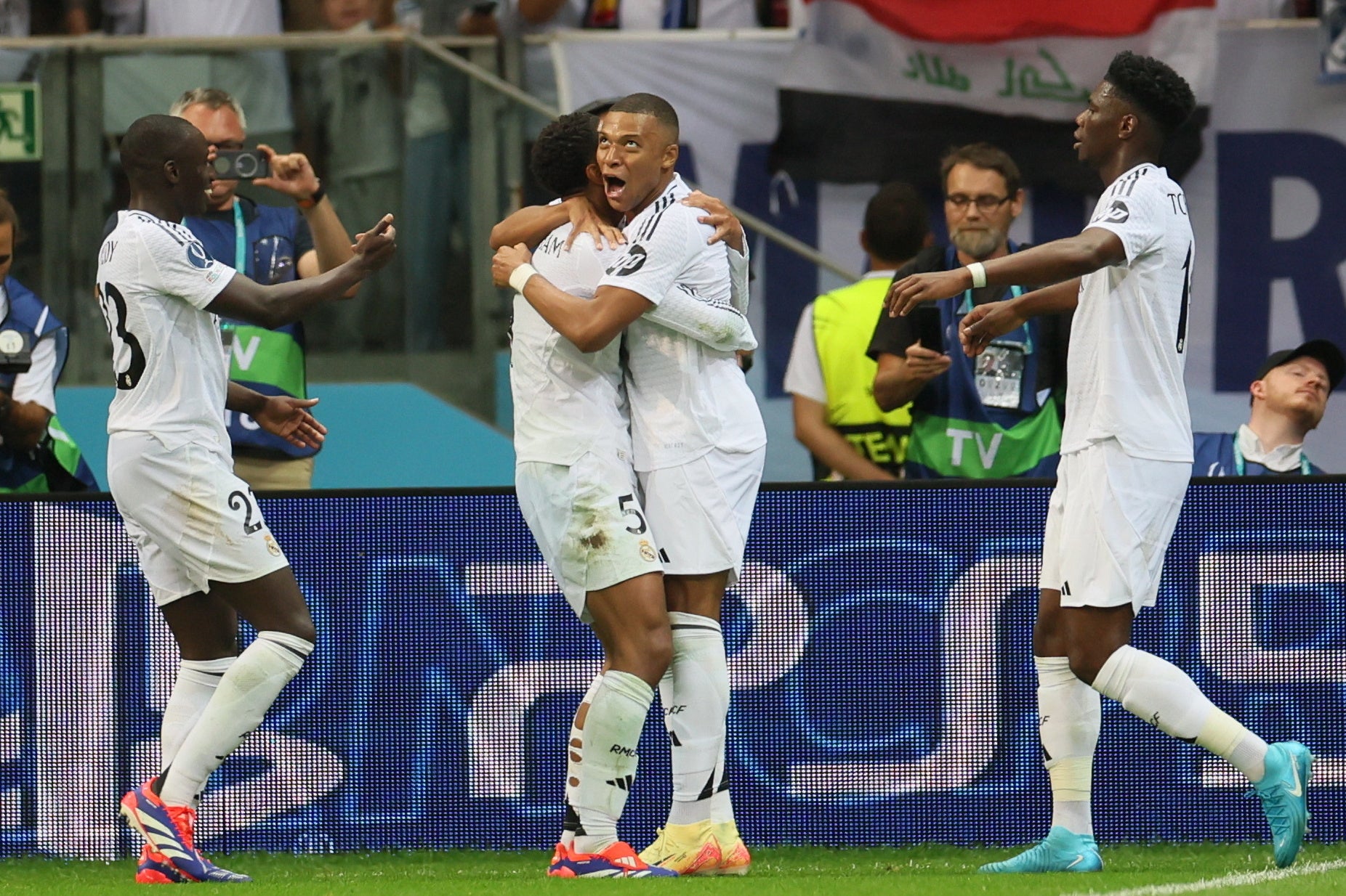 Kylian Mbappe (C) celebrates after scoring