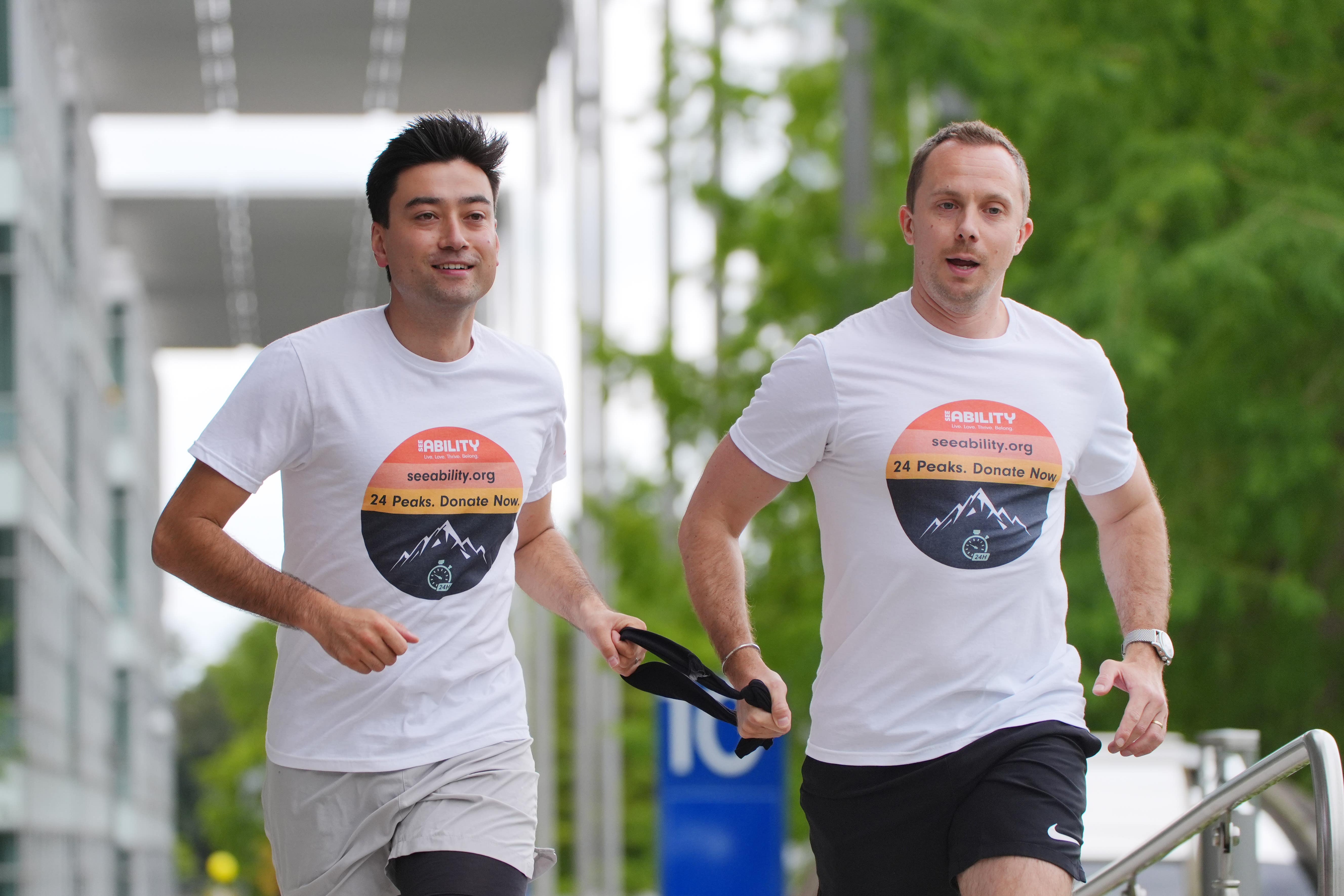 Blind lawyer Michael Smith (left) will be tethered to his boss, Jack Stacy (right) for 24 hours as they take on 24 mountain peaks for charity (Jonathan Brady/PA)