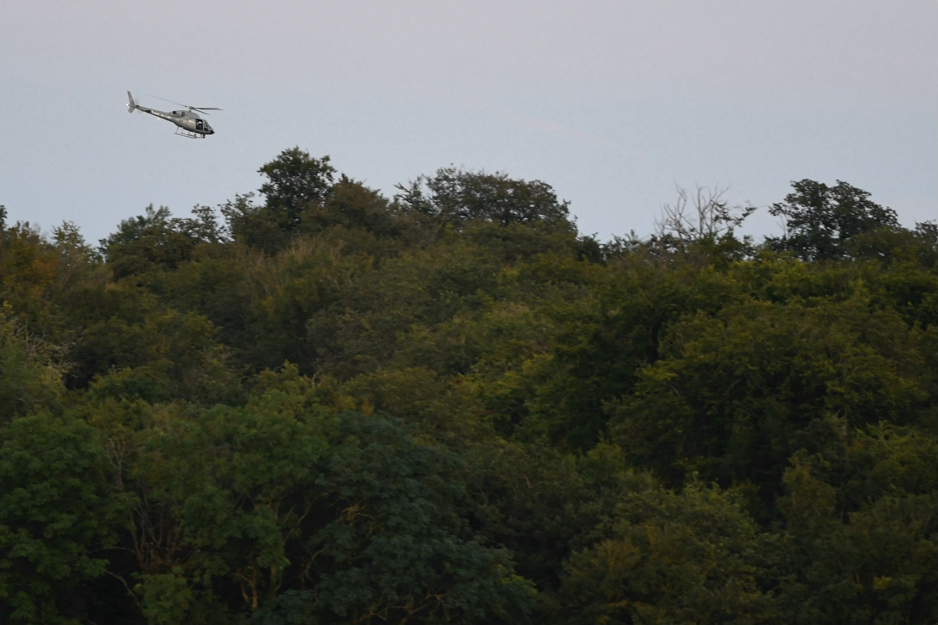 A helicopter from the French Air Force takes part in a search operation in Autreville, eastern France following a crash between two French military Rafale jets