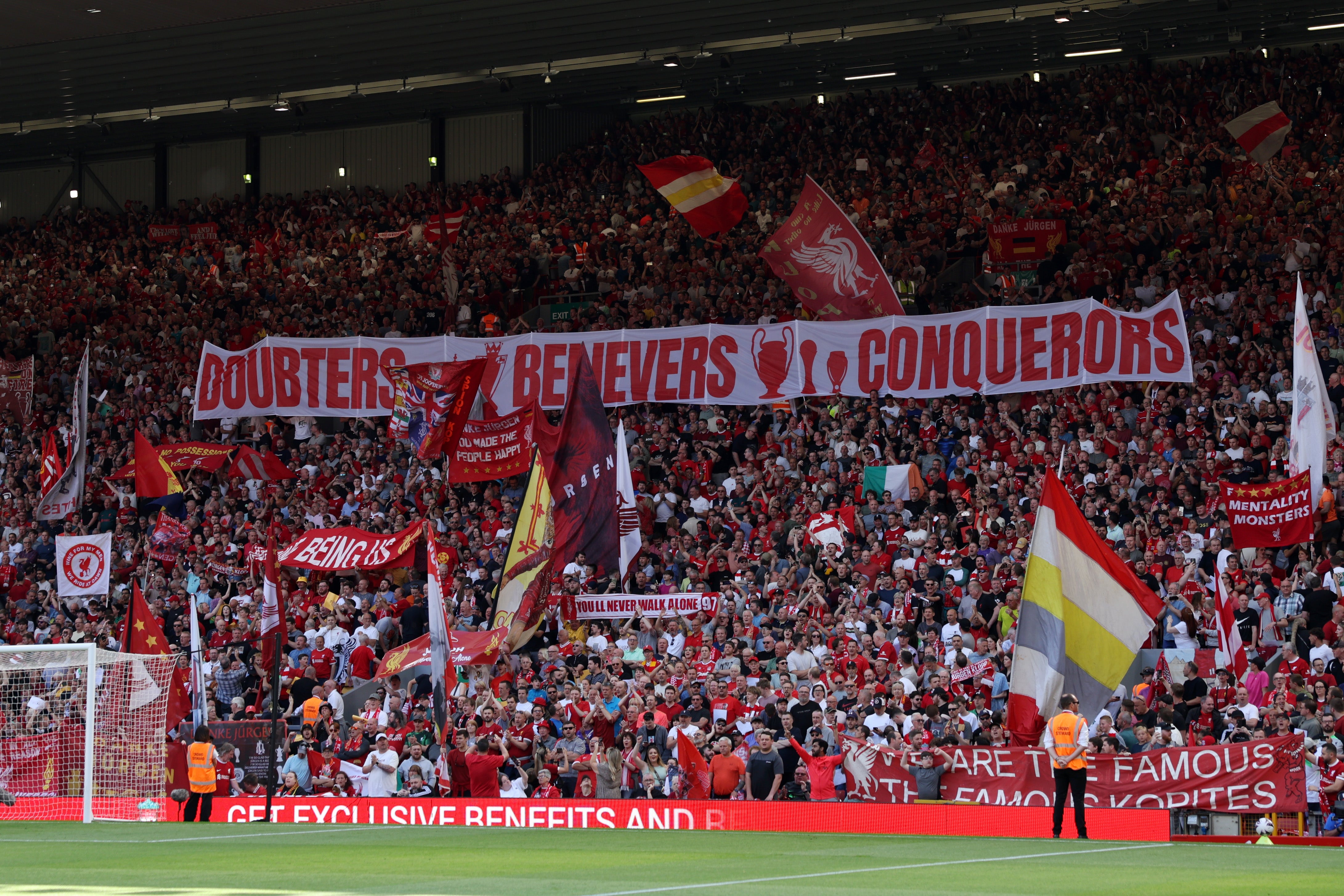 Fans of Liverpool display a banner