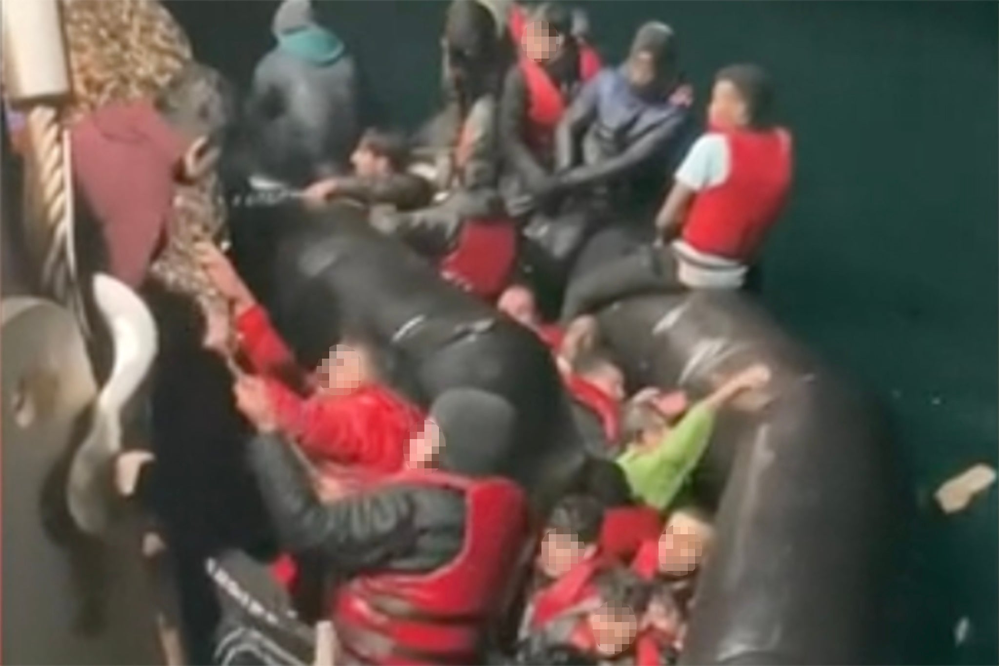 Migrants are rescued from a collapsing dinghy in the Channel on 14 December 2022