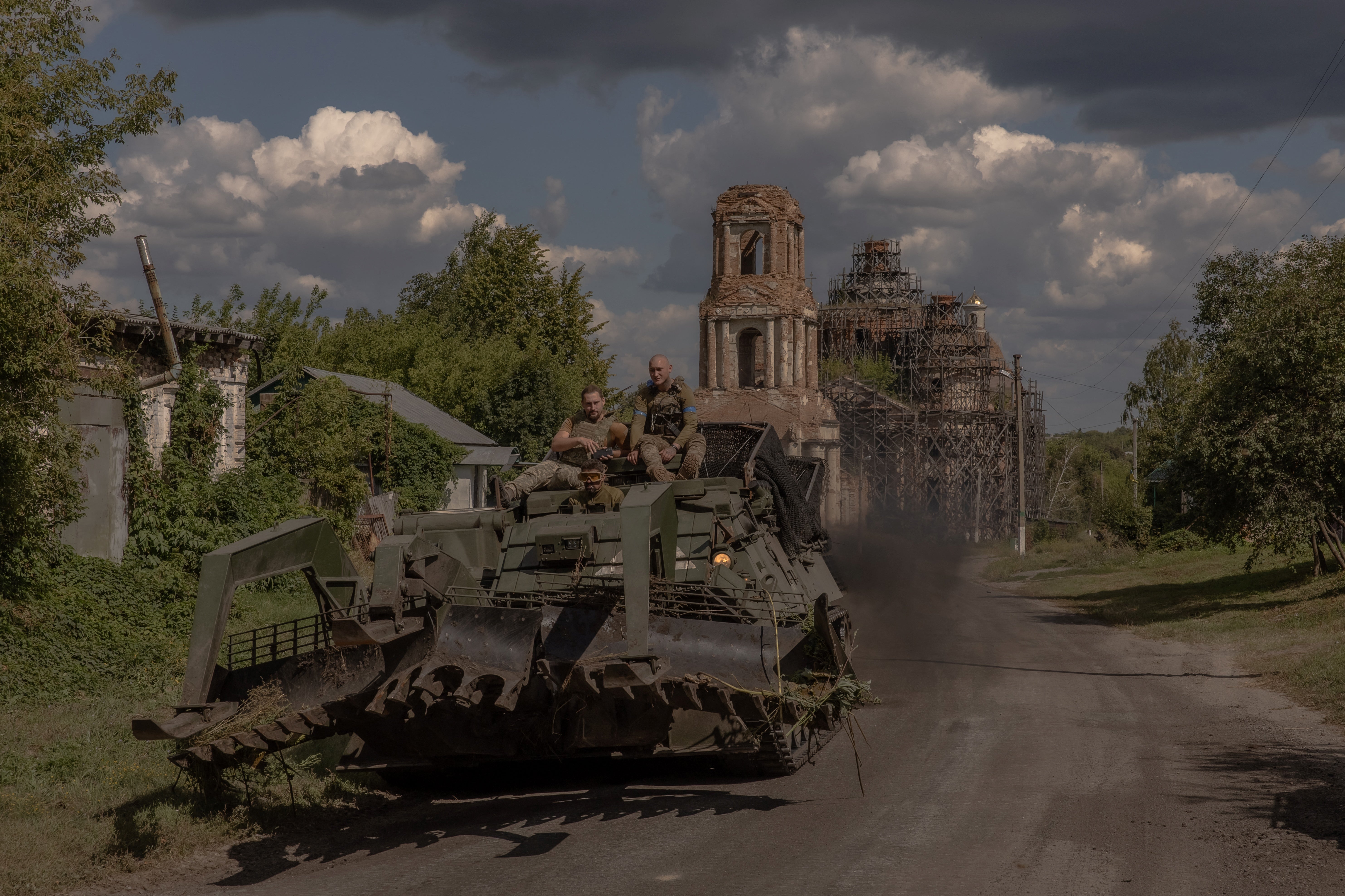 Ukrainian service personnel operate an armoured military vehicle on a road near the border with Russia, in the Sumy region of Ukraine