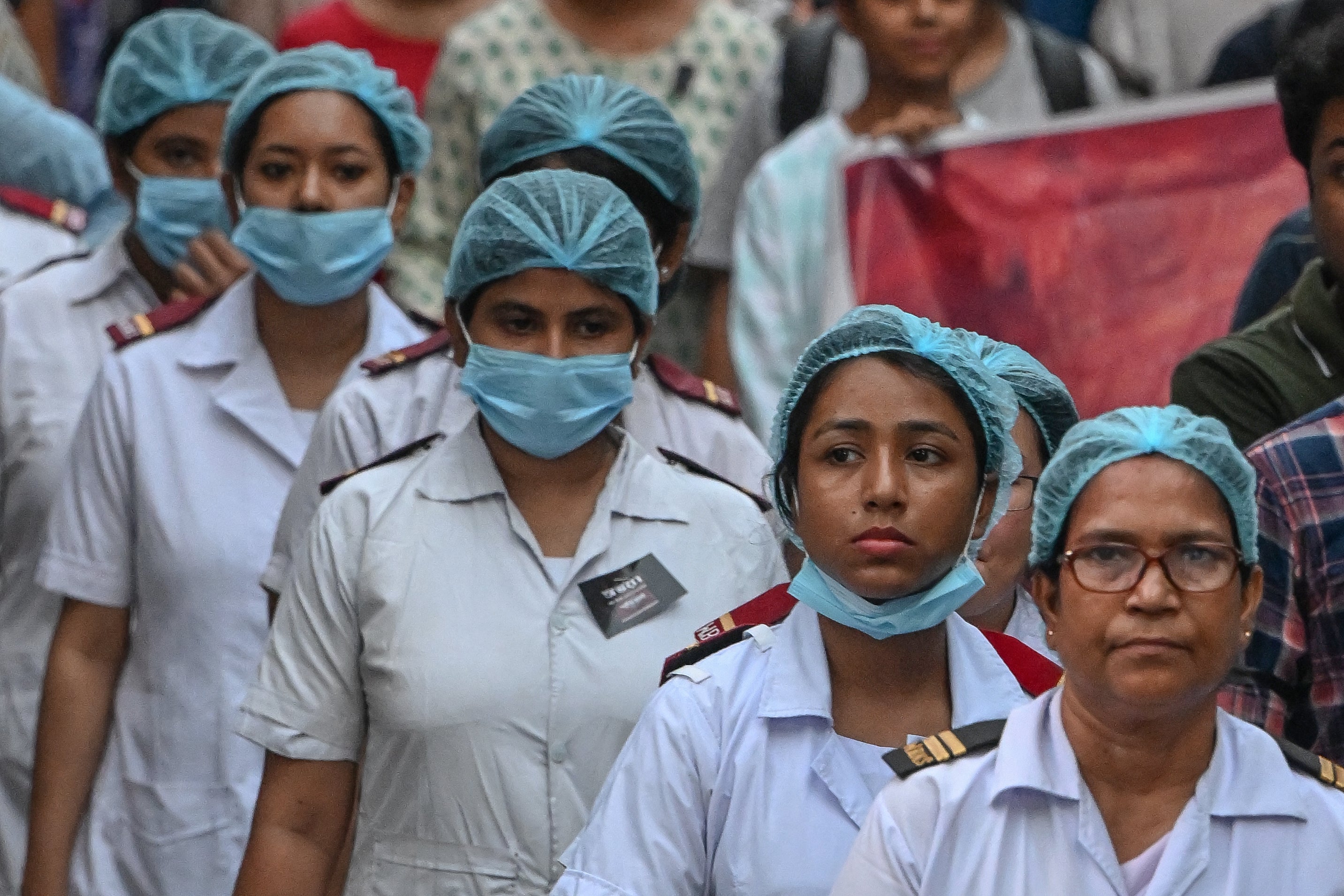 Medical professionals participate in a silent march as they condemn the rape and murder of a doctor, in Kolkata